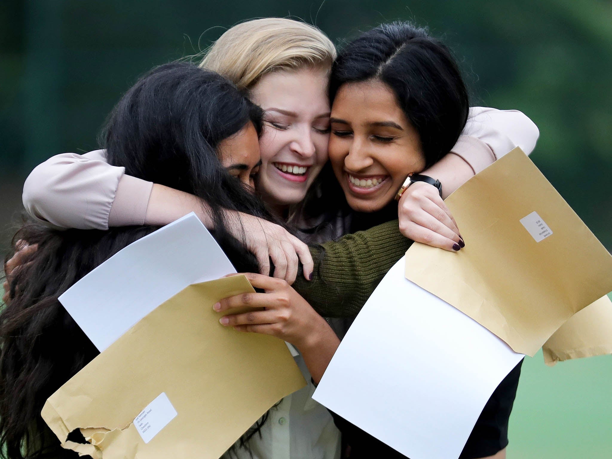 Withington Girls' School pupils react as they open their GCSE exam results