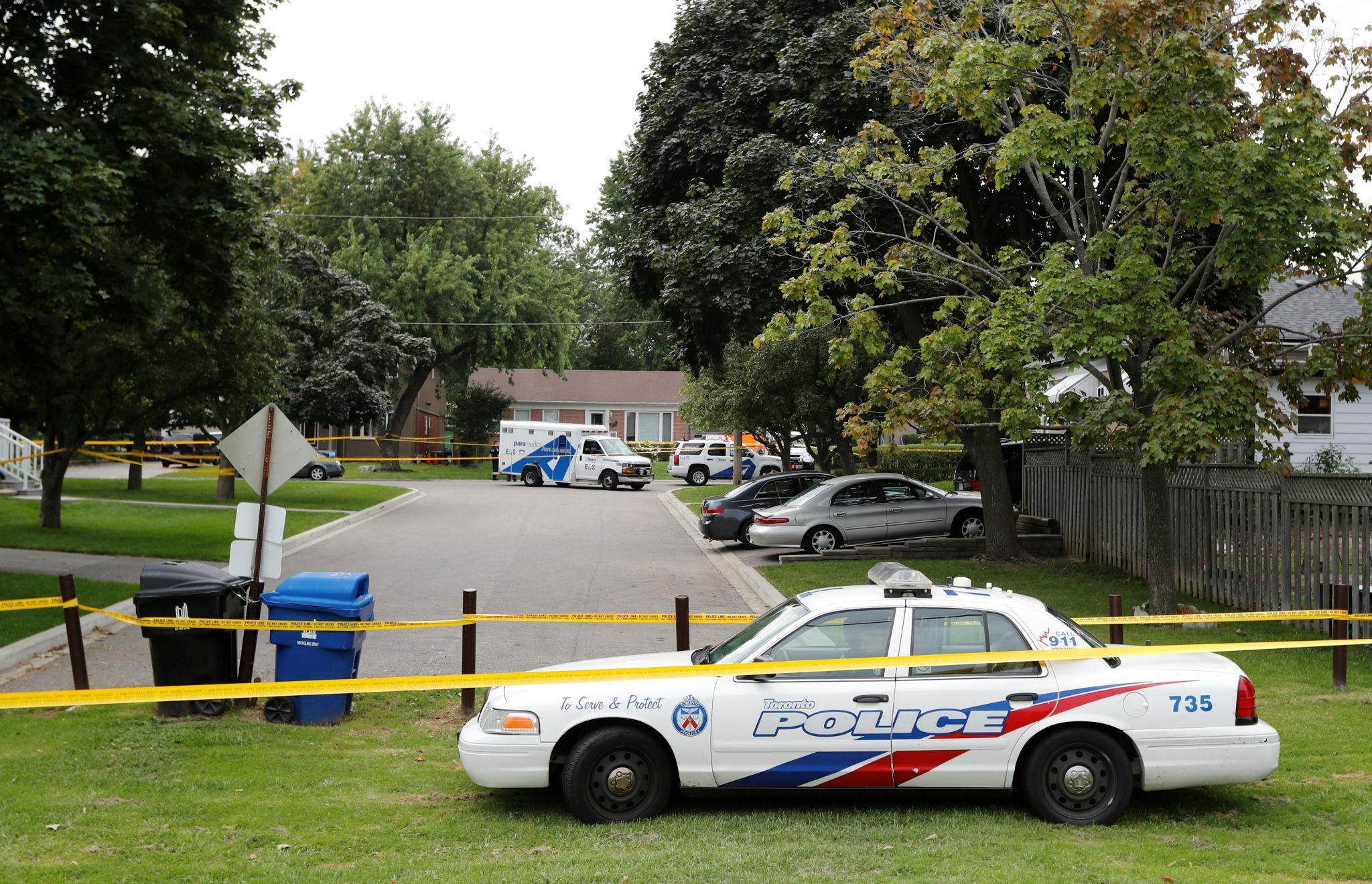 Toronto police cordon off the area outside the house where Brett Ryan killed his mother and two of his brothers