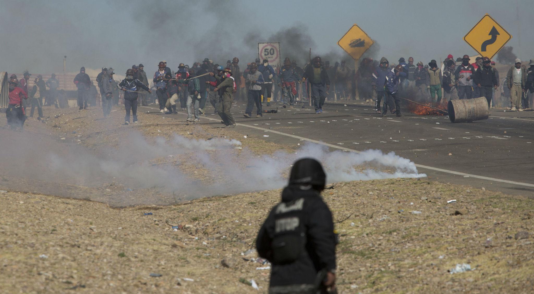 Striking miners clash with police after blocking a highway outside La Paz