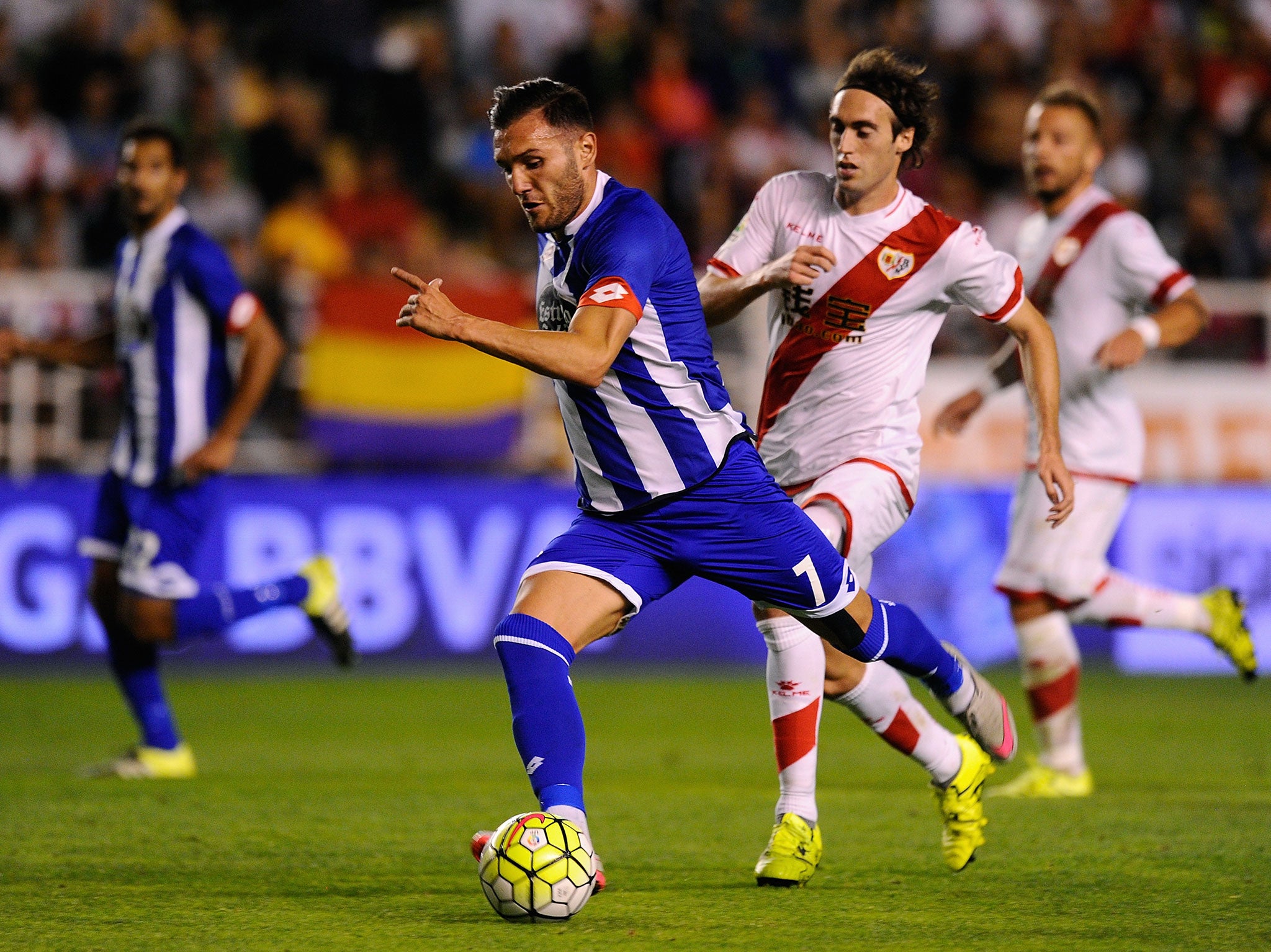 Lucas Perez of RC Deportivo la Coruna gets past Raul Baena of Rayo Vallecano