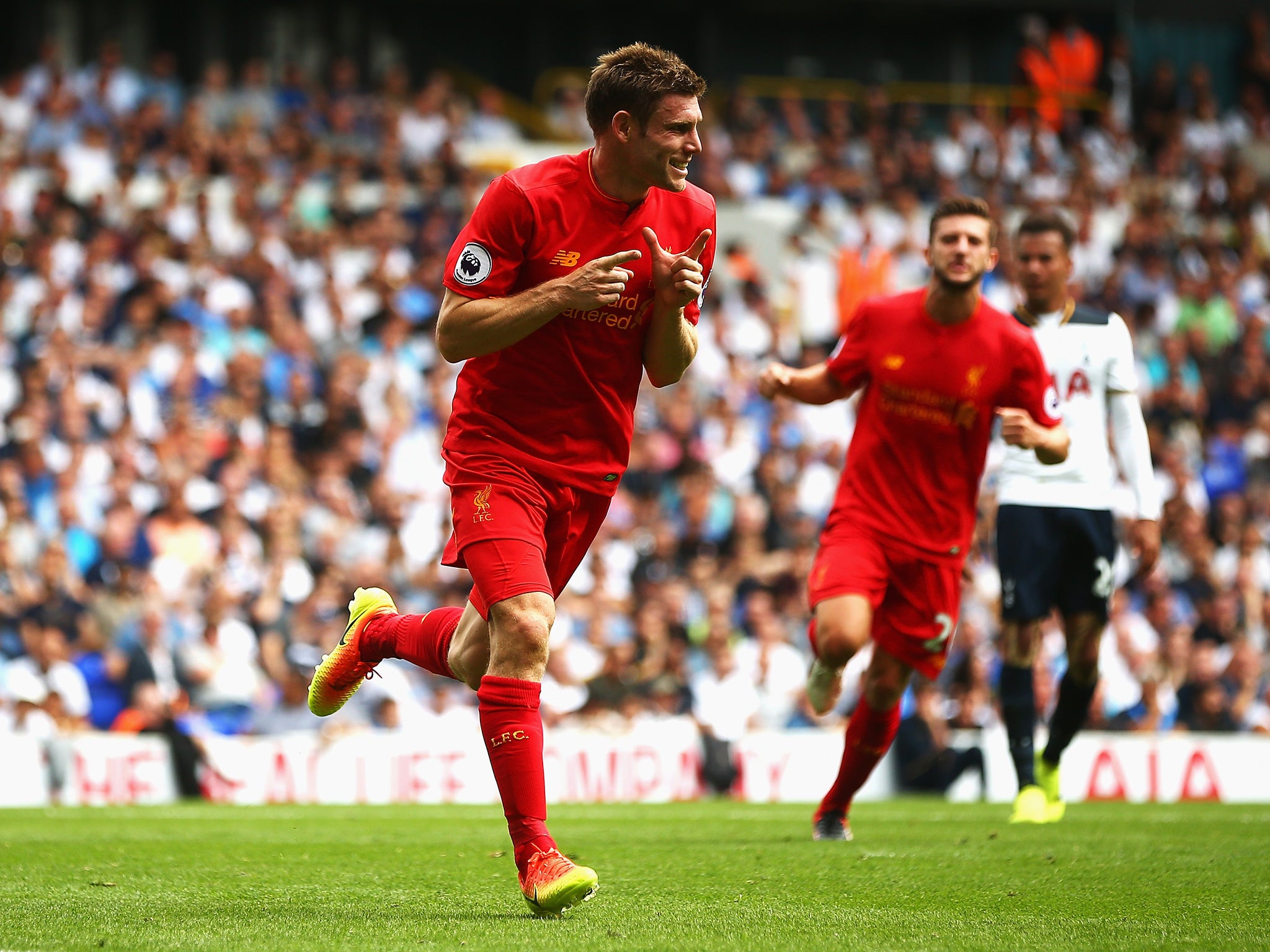 Milner celebrates scoring from the spot to give Liverpool the lead