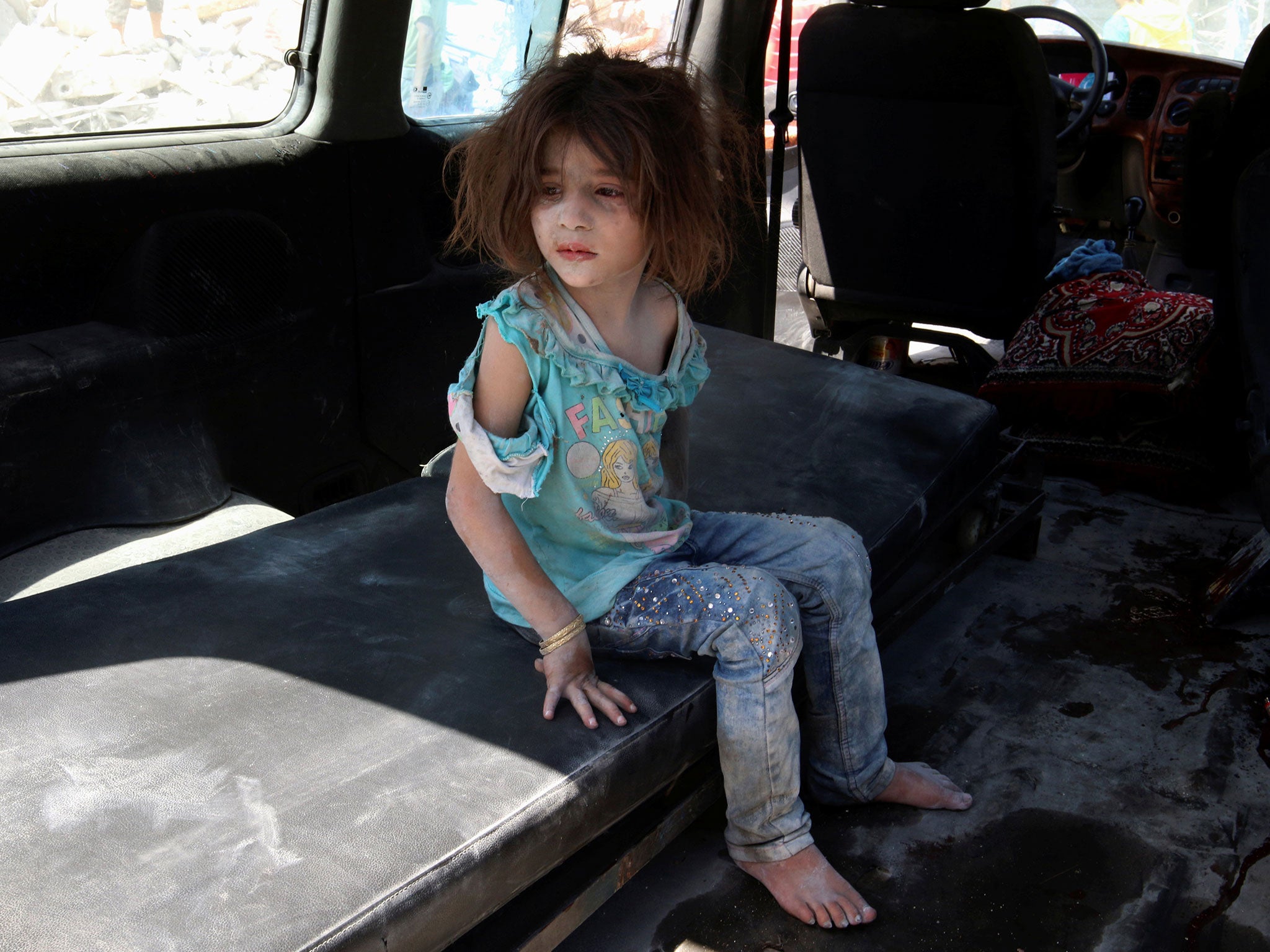 A girl who survived bombing on the rebel held Bab al-Nayrab neighborhood of Aleppo on 27 August