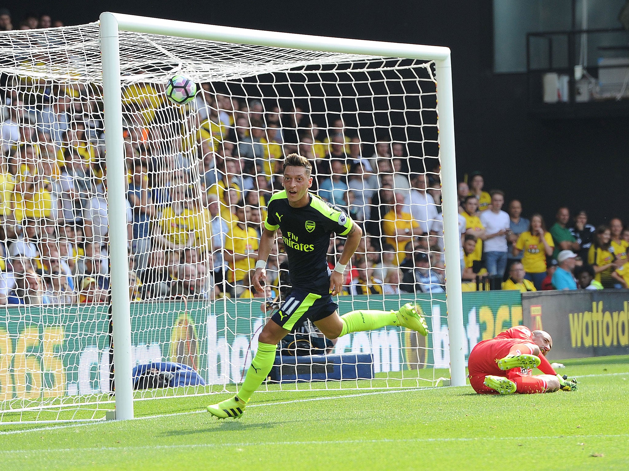 Mesut Ozil wheels away after scoring Arsenal's third