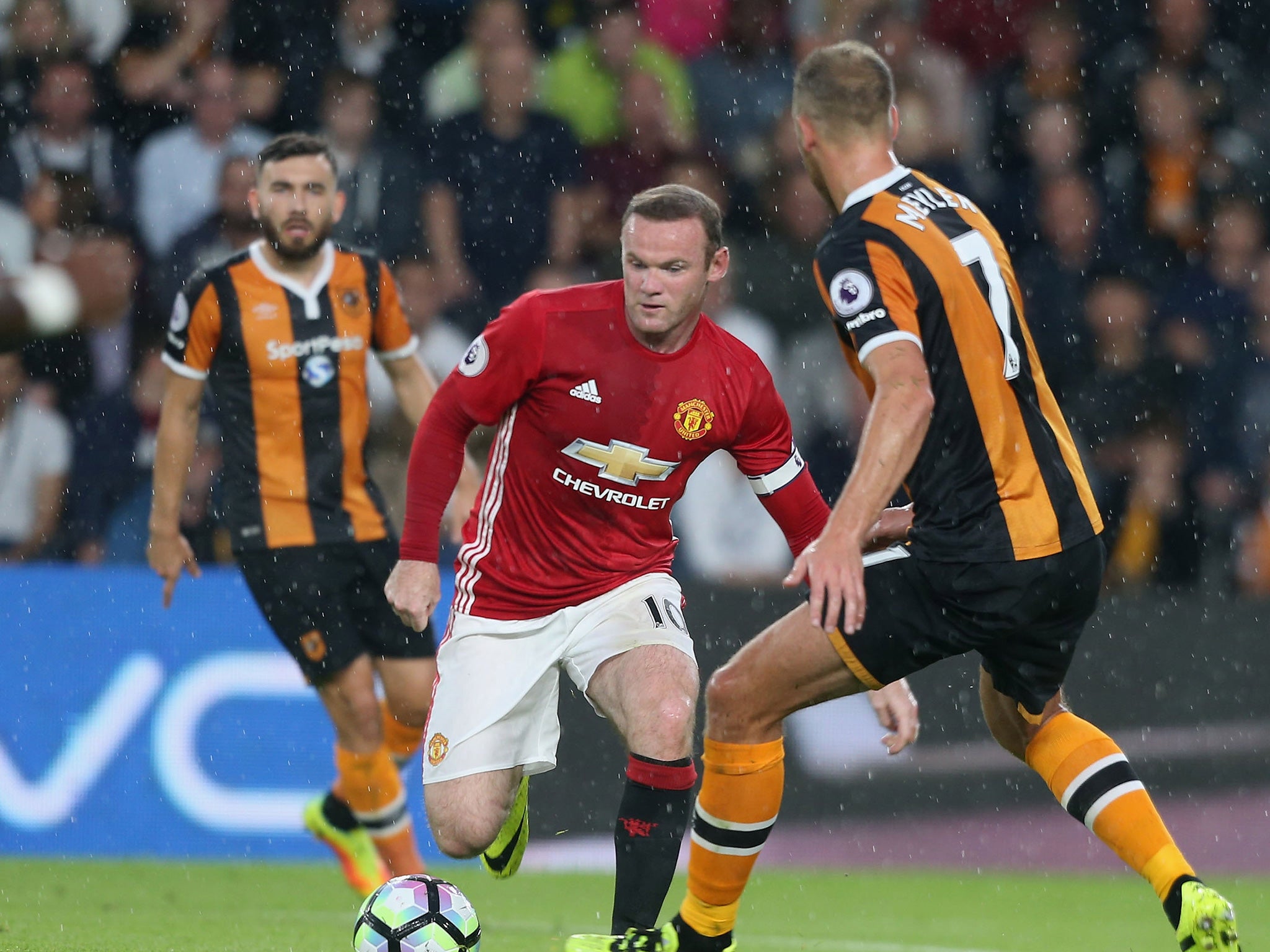 Rooney evades Meyler's tackle at the KCOM Stadium