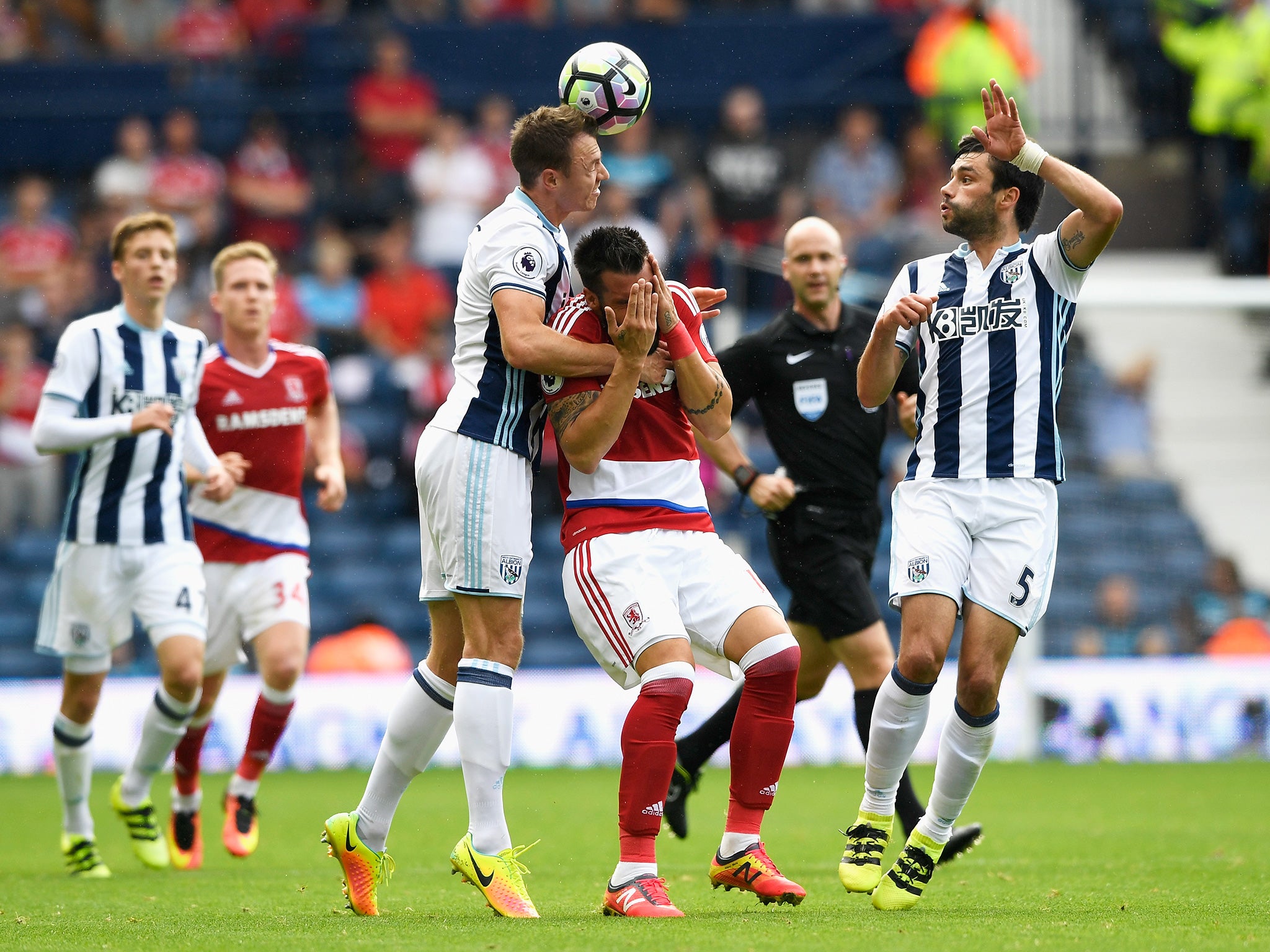 Negredo holds his face after a duel with Evans