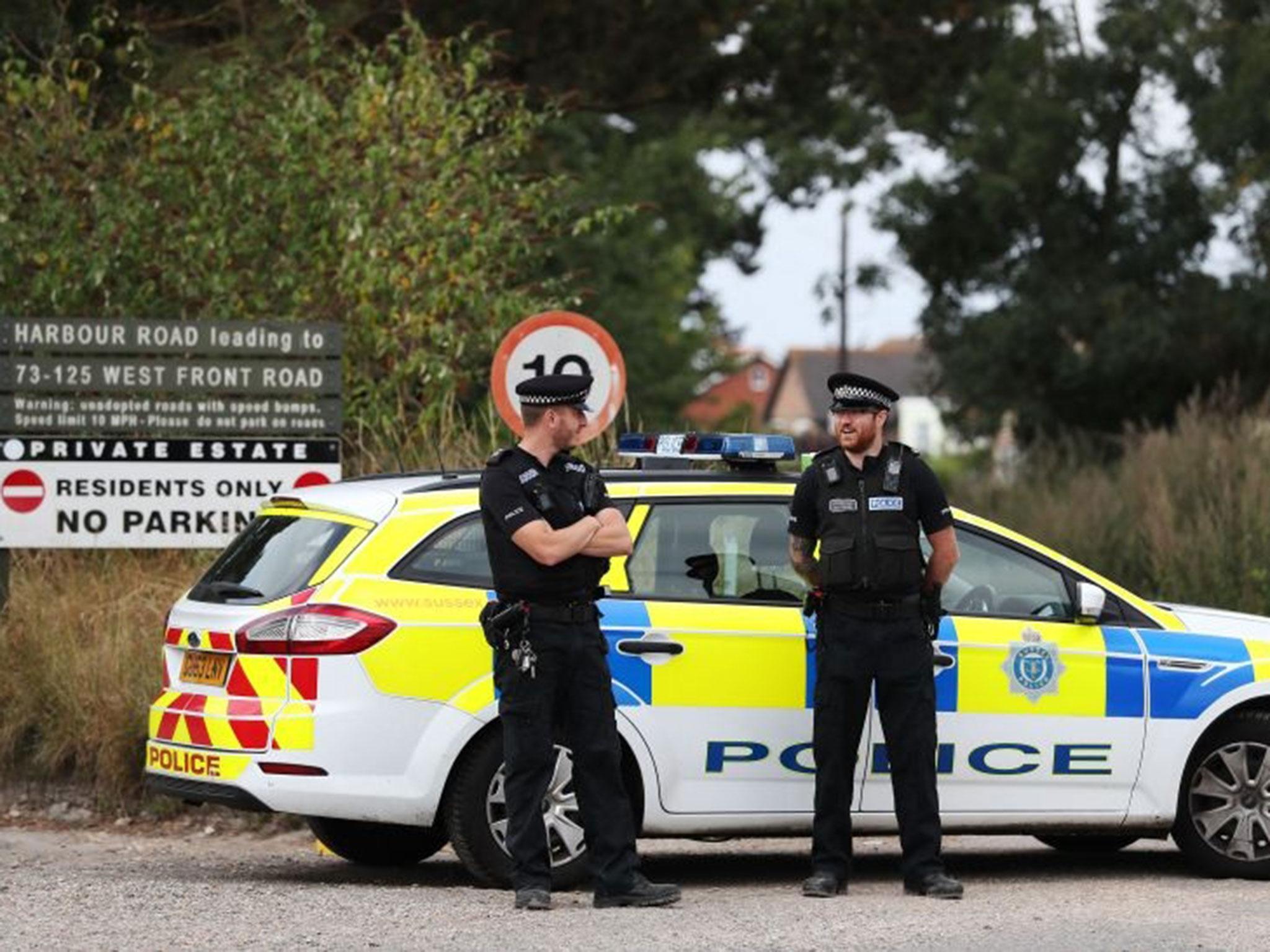 Police at the scene on Harbour Road, Pagham, West Sussex, where they are in a stand-off with a 72-year-old man who is thought to have a gun