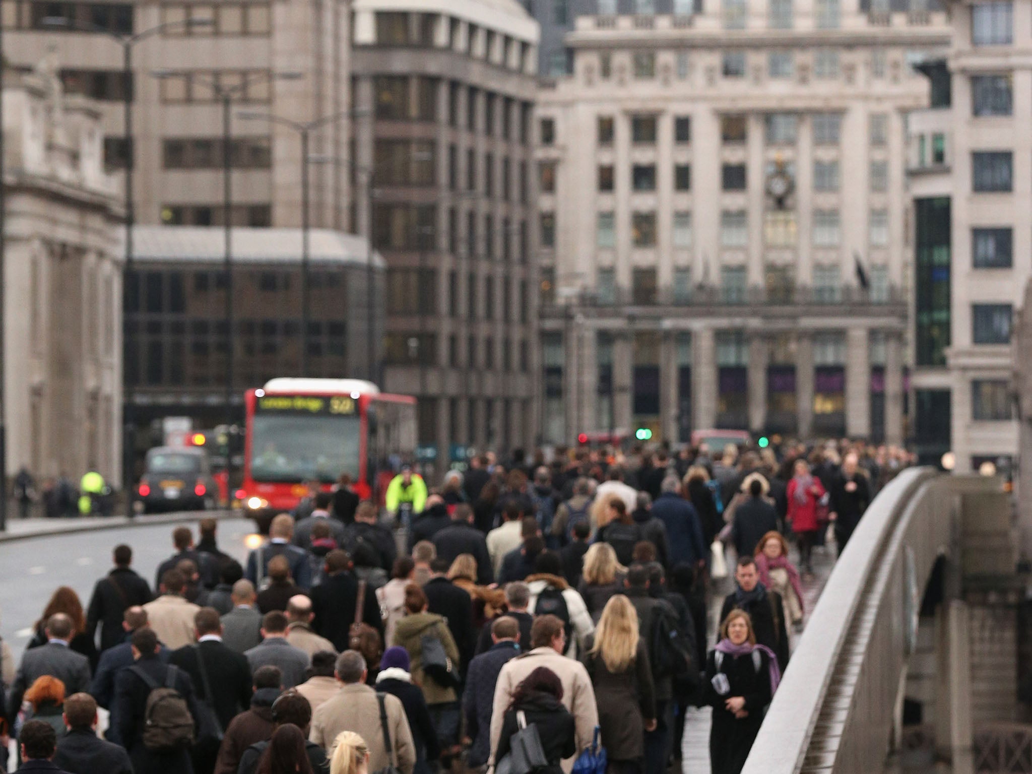 City workers cross London Bridge as they commute to work