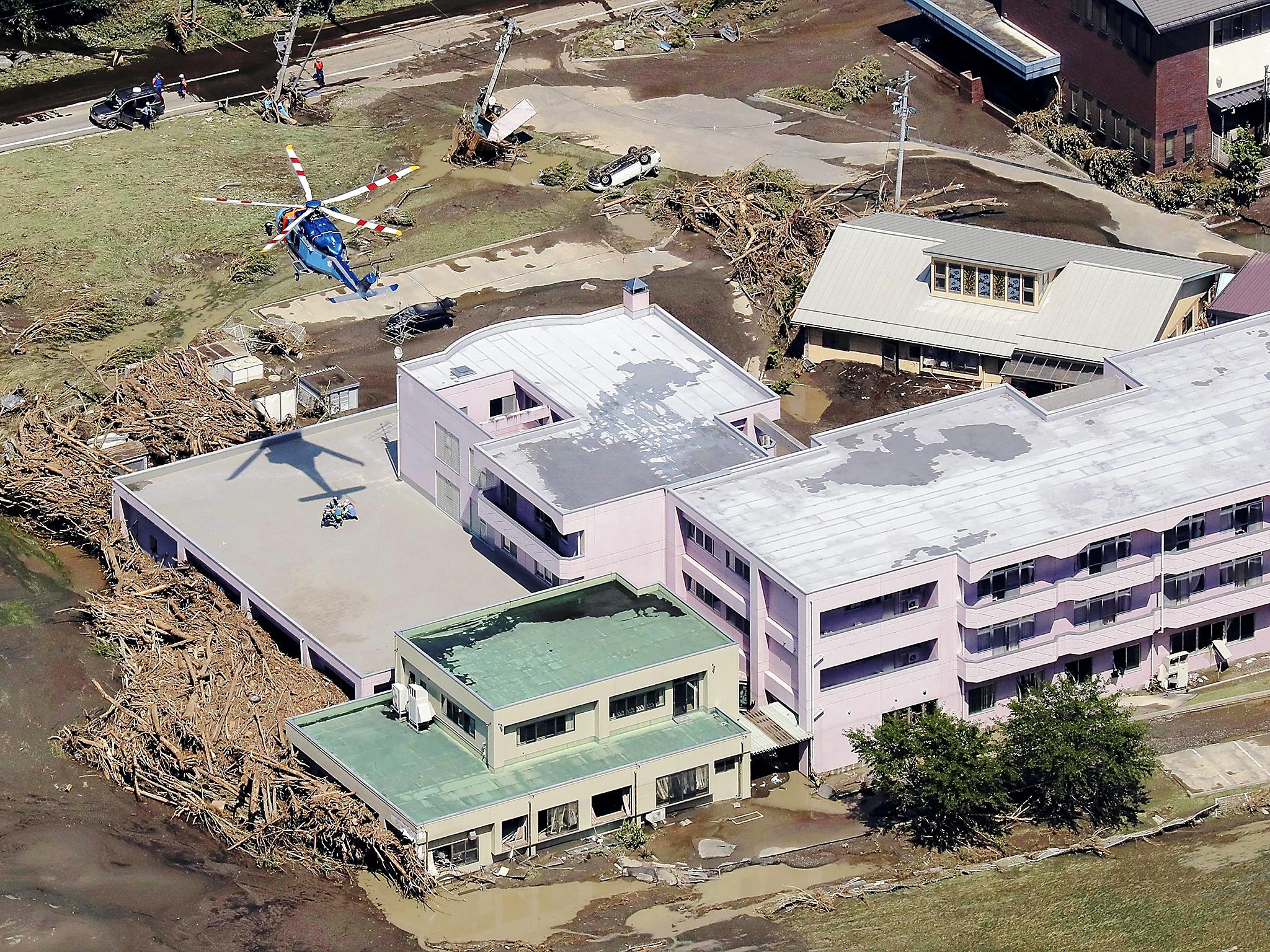 Helicopters assist with rescue operations at the Ran Ran elderly nursing home, where nine people were found dead following floods due to heavy rains generated by typhoon Lionrock in Iwaizumi, Iwate prefecture