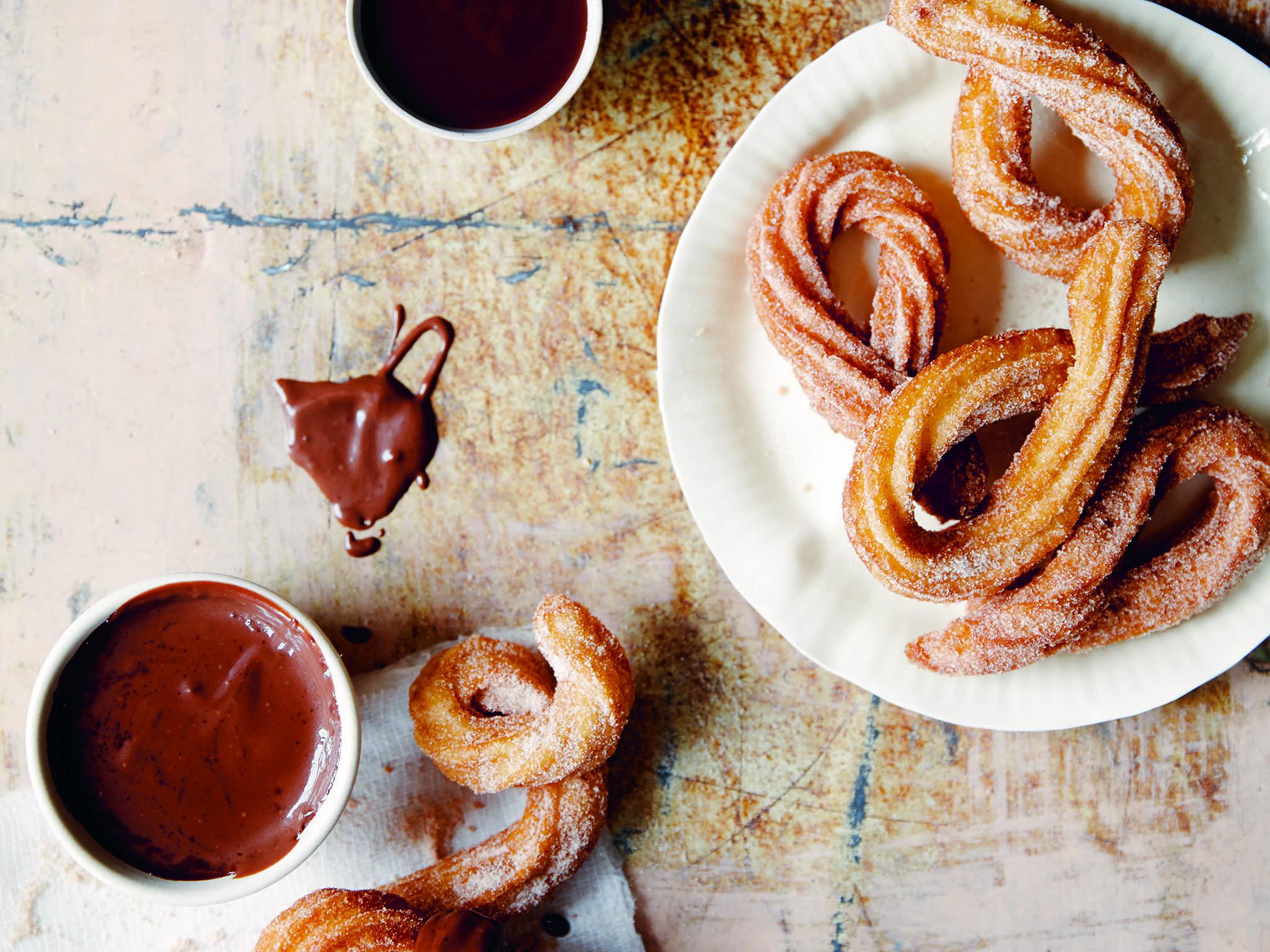 Homemade churros are fried choux pastry covered in sugar and dipped in chocolate sauce