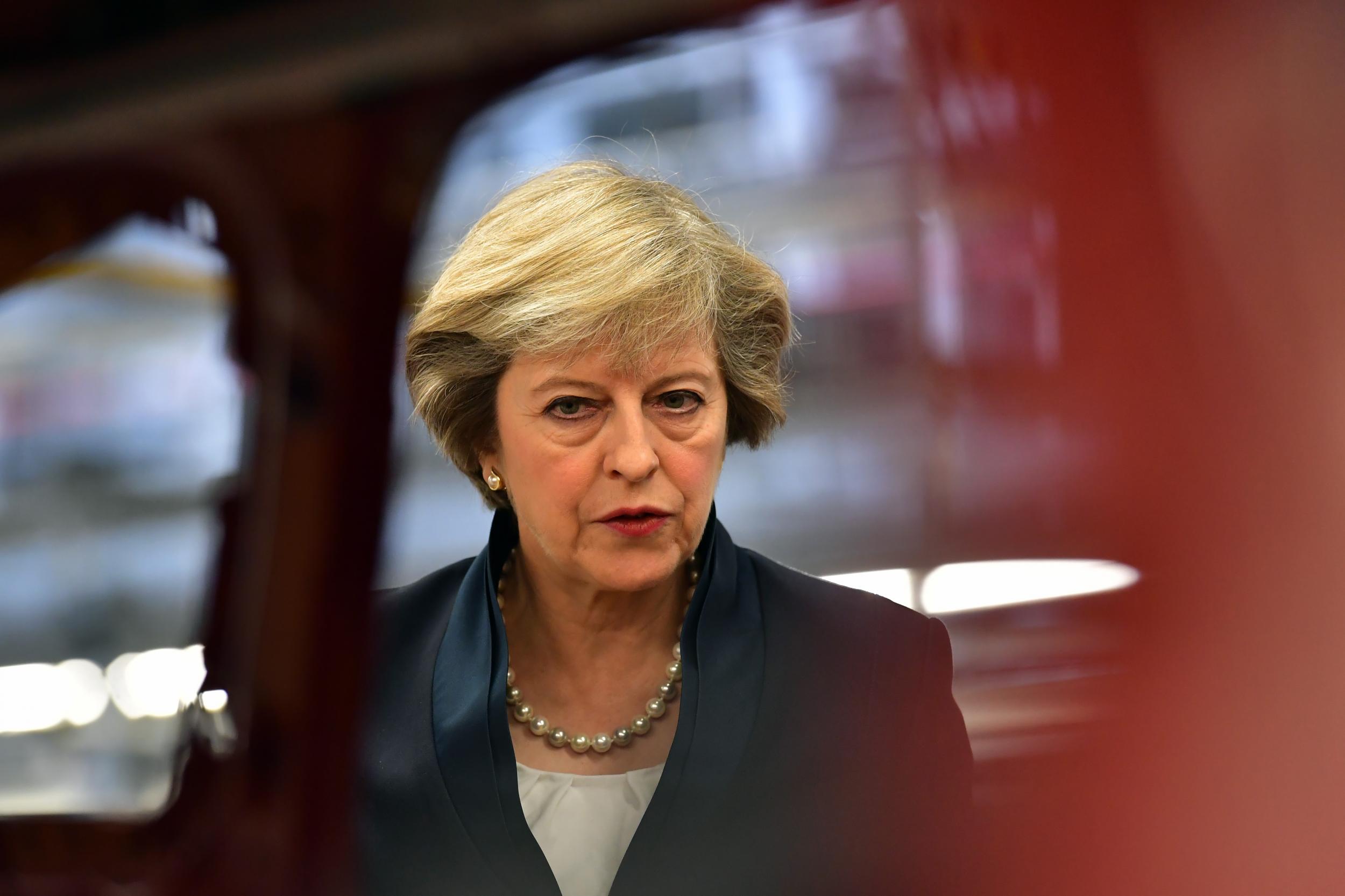 Prime Minister Theresa May views a car on a production line