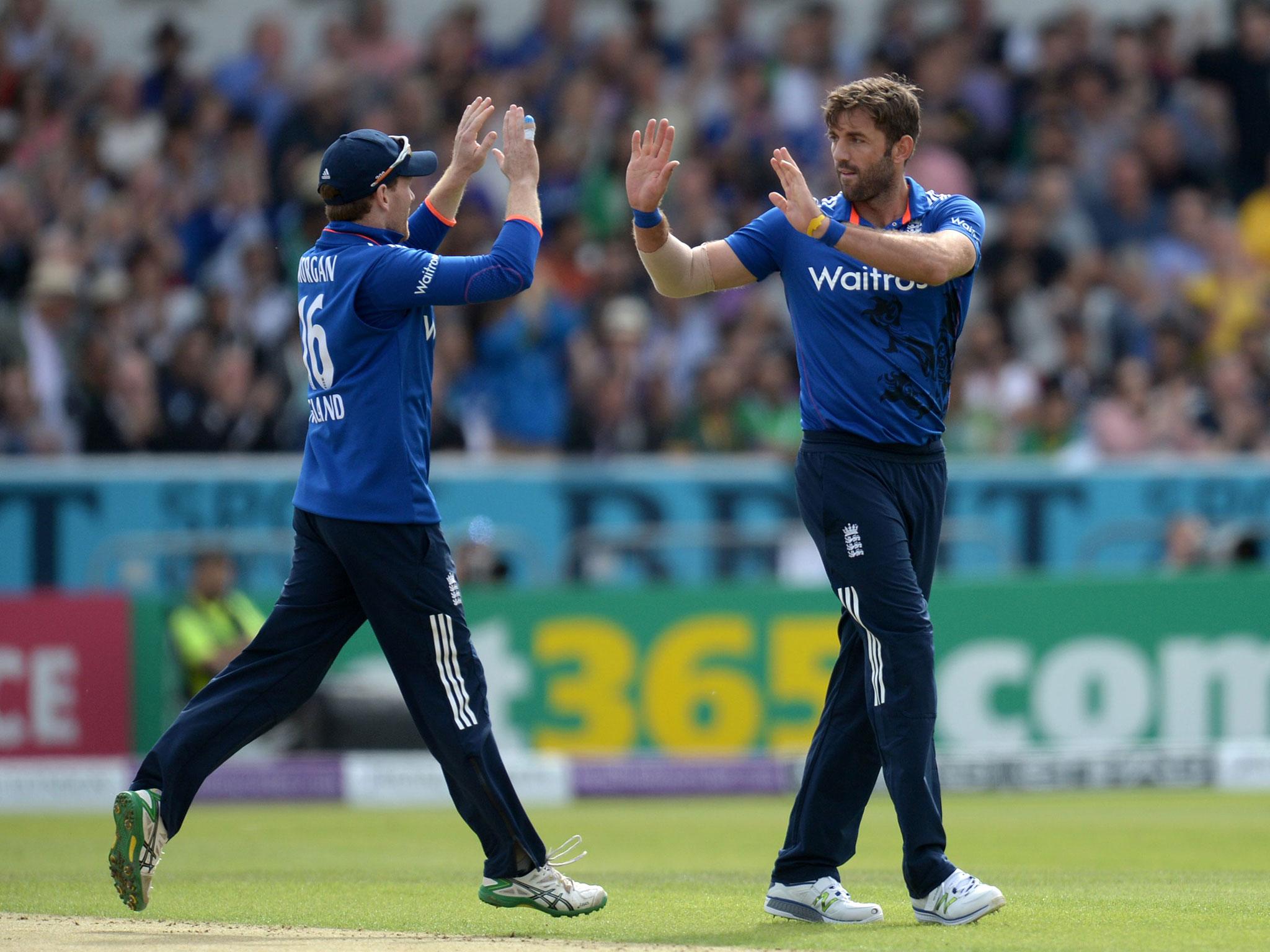 Liam Plunkett (right) celebrates with his captain Eoin Morgan after taking the wicket of Pakistan's Sami Aslam