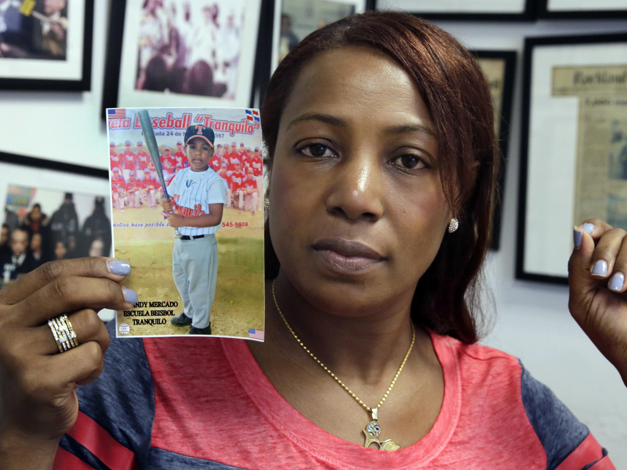 Maribel Martinez with a photo of her 5-year-old son Andy at her lawyer's office in New York