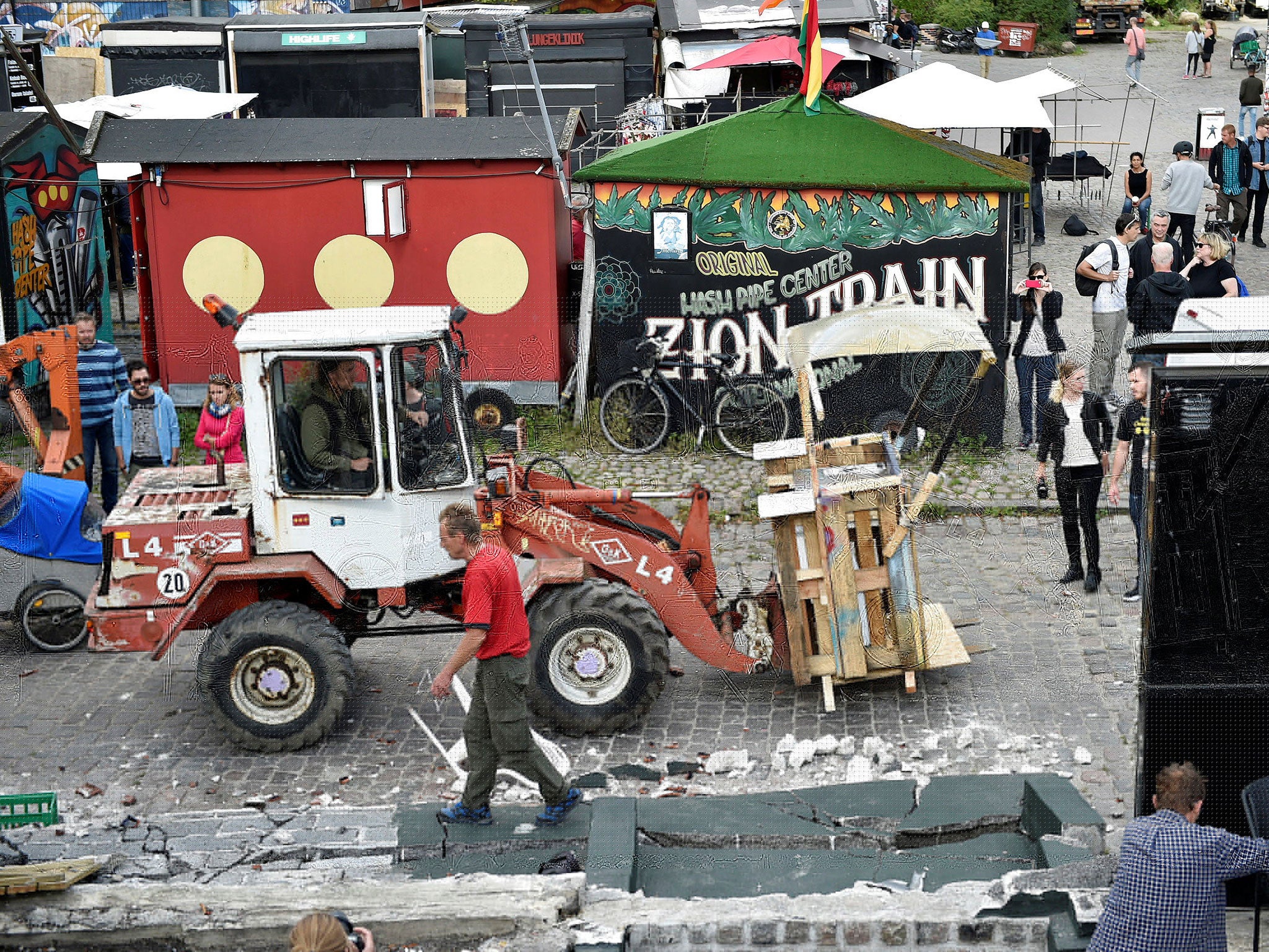 Residents demolish cannabis vending stalls following a shooting in Christiania, Copenhagen, Denmark September 2, 2016.