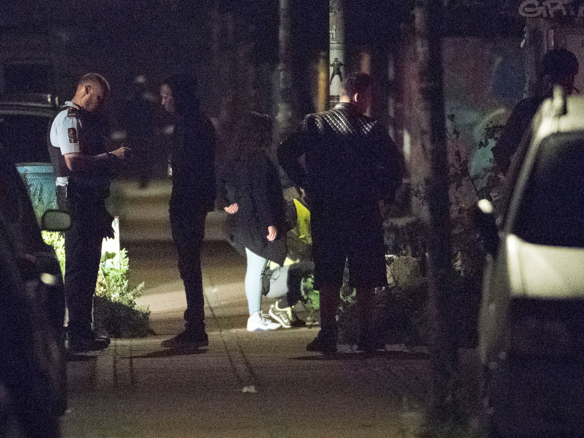 Policemen ask questions to people after a shooting in Christiania, Copenhagen on 1 September.