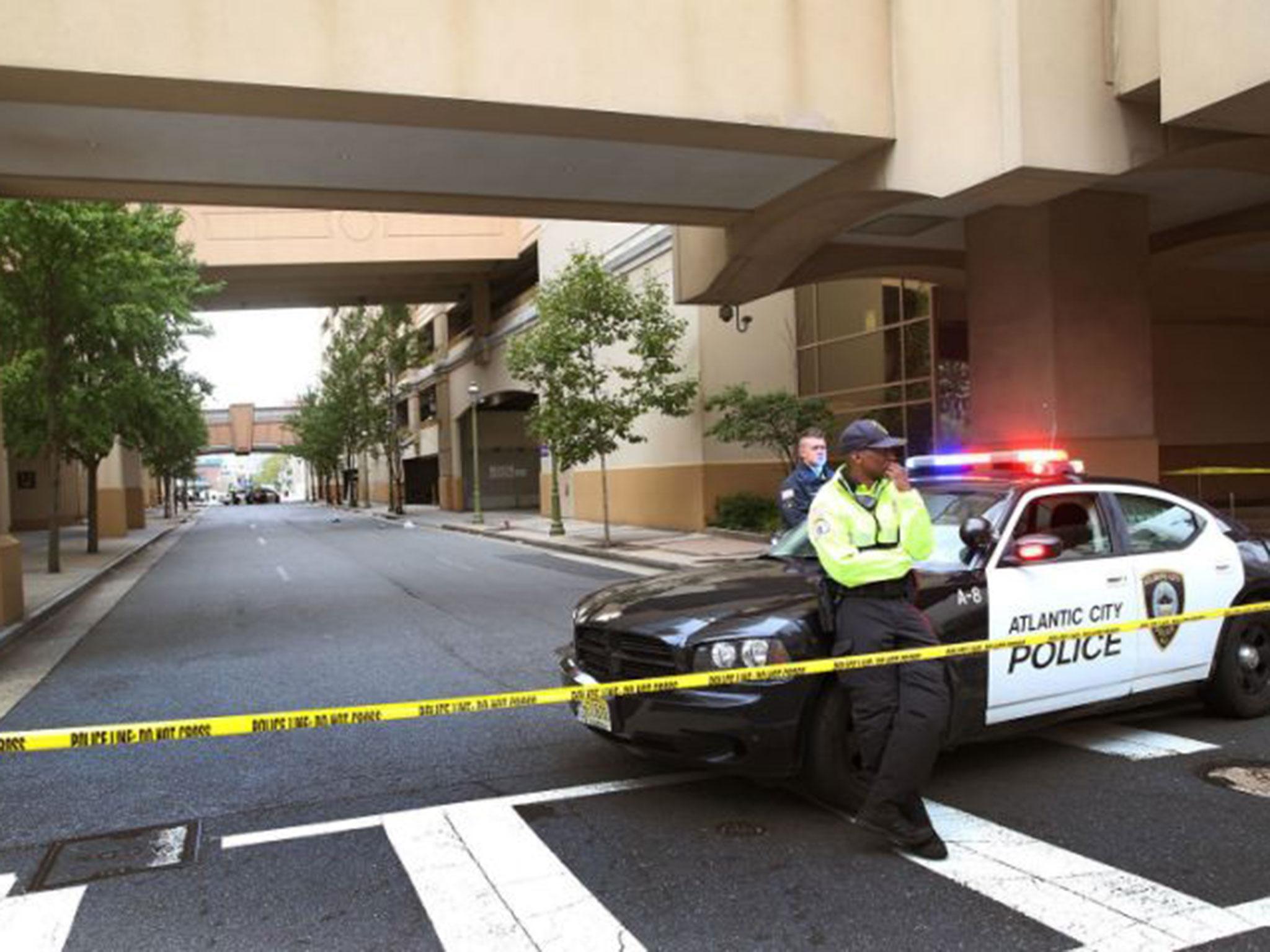 A police officer stands guard near the scene of the shooting