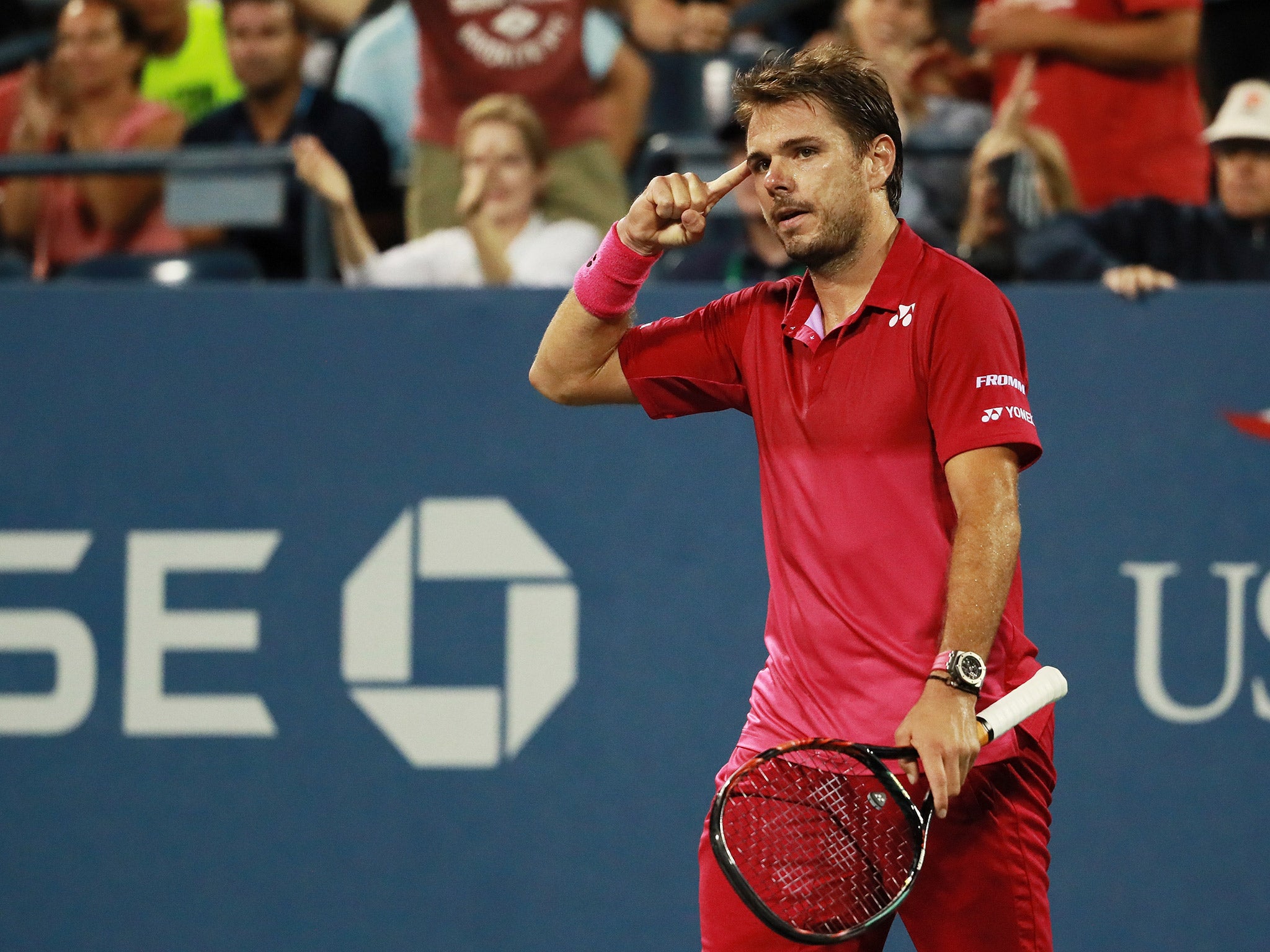 Wawrinka celebrates after clinching a five-set victory over Evans