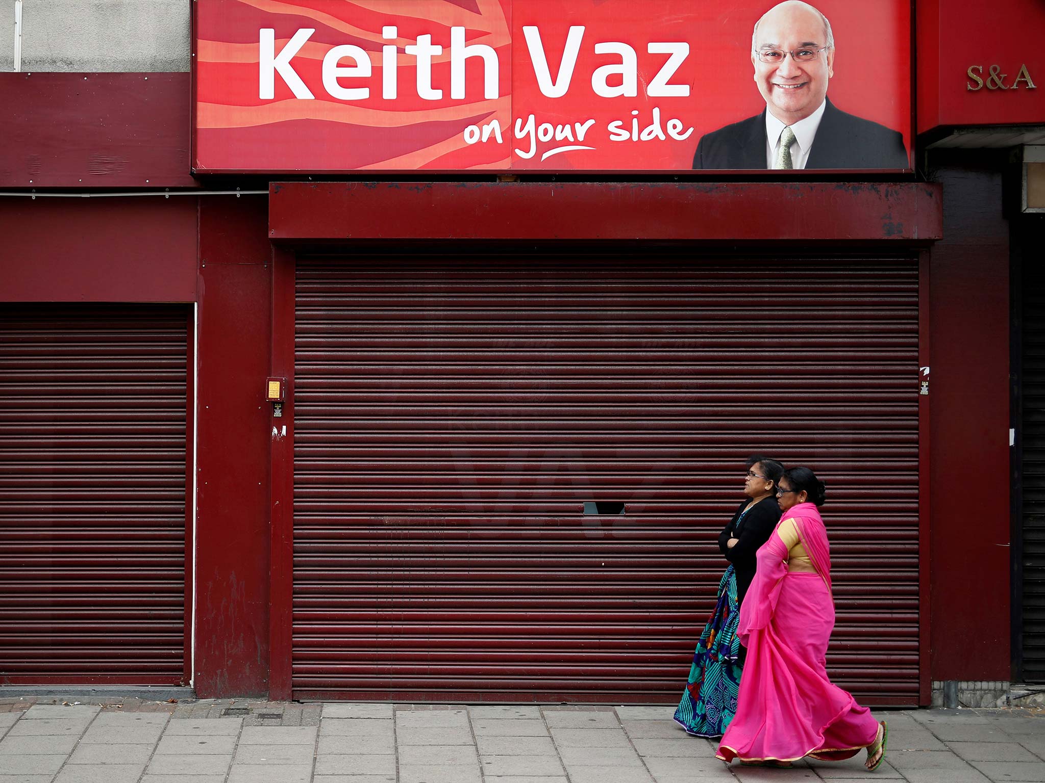 Women pass the Leicester East constituency office of Keith Vaz today. In almost three decades as the Hon. Member, he has proved himself 'a gifted self-publicist'