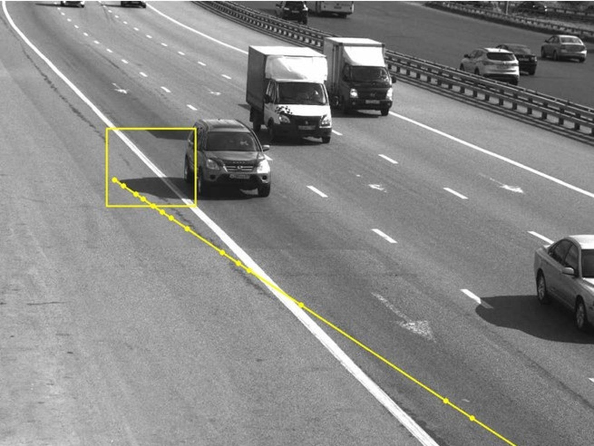 Photos taken by traffic cameras show only the car's shadow crossed the line