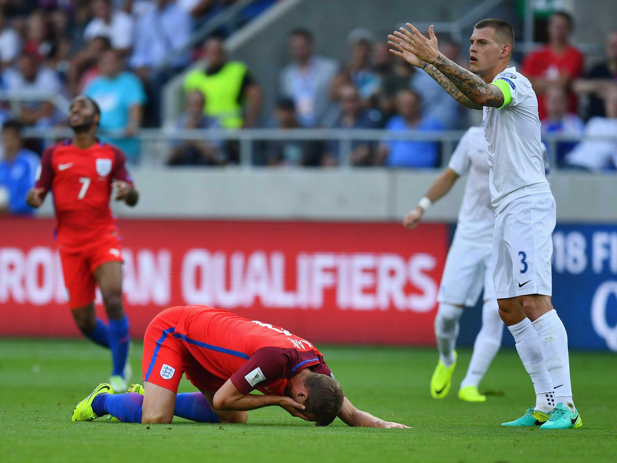 Martin Skrtel protests his first booking after elbowing Harry Kane