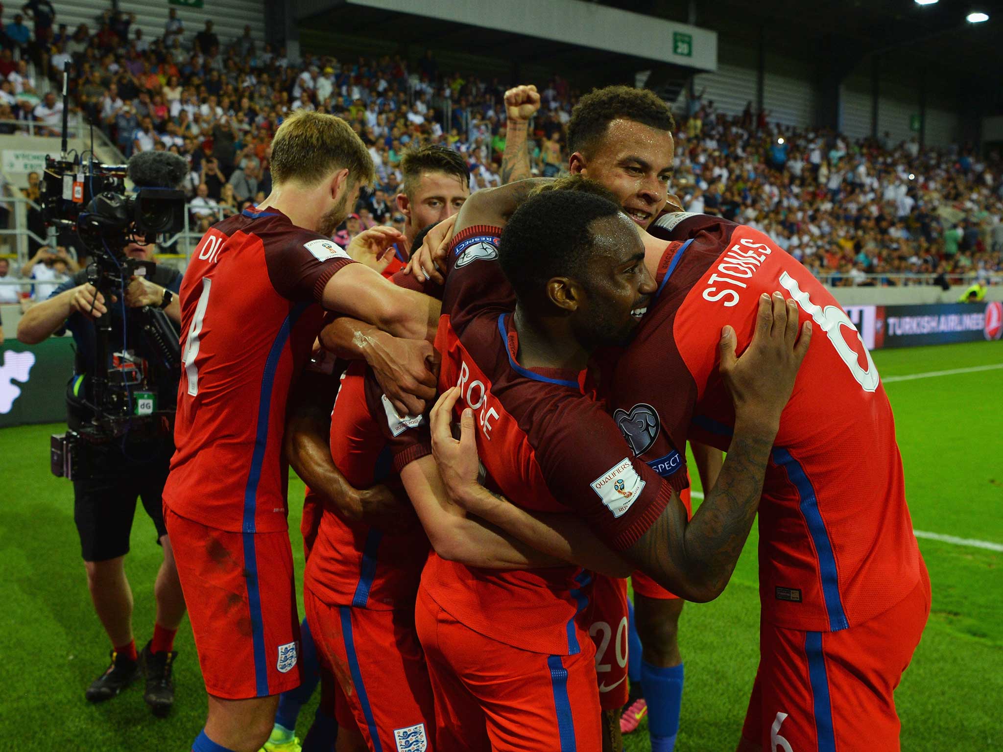 Adam Lallana is mobbed by his England team-mates after scoring a last-ditch winner