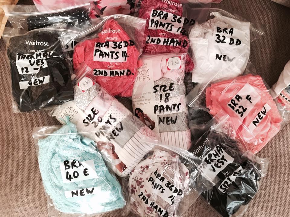 Mis Kerr sorts through the underwear in her living room, dividing the items by size into carefully labelled packages