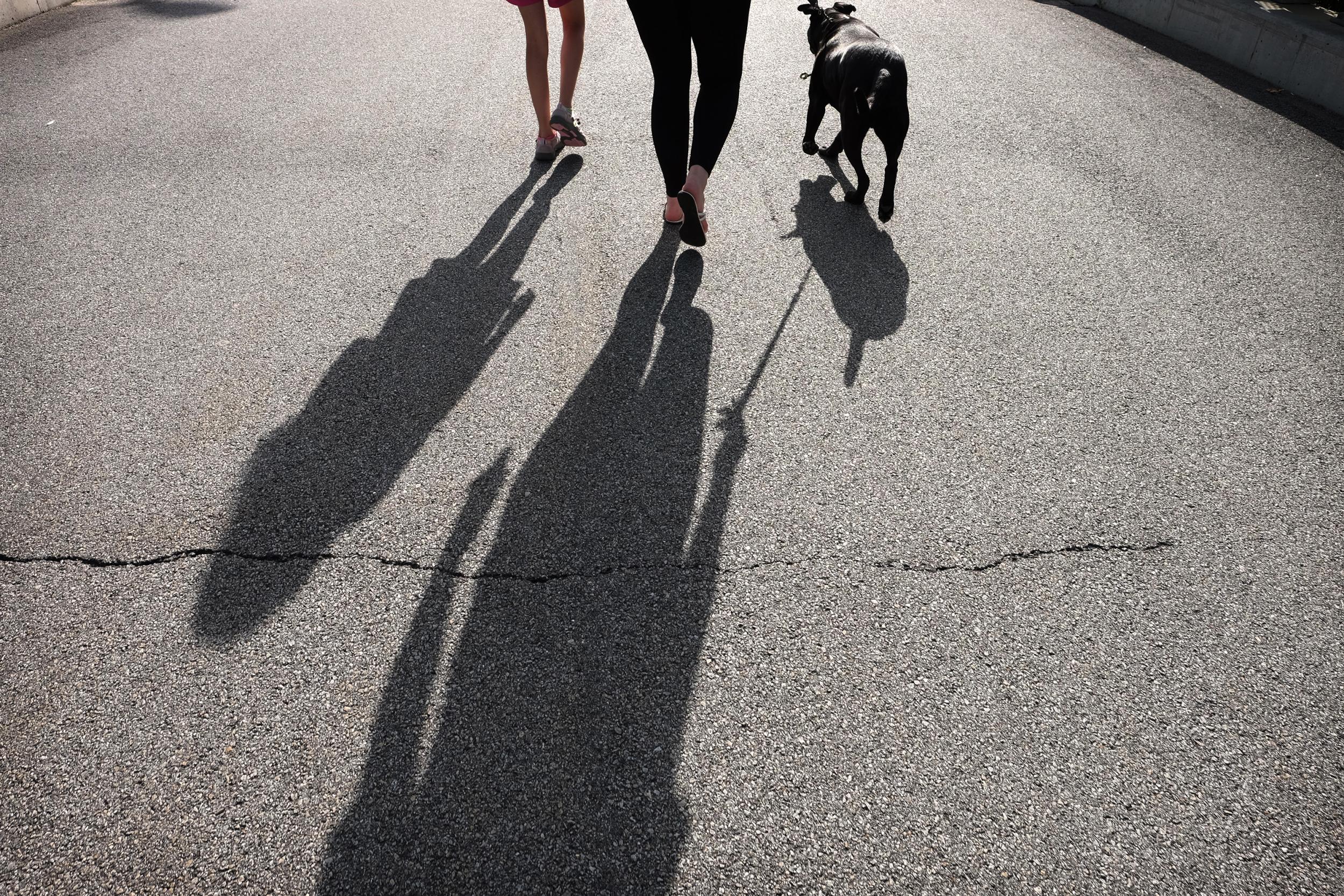 Maureen and her sister walk with their dog on an August afternoon. At the end of the month, Maureen started her sophomore year of high school.