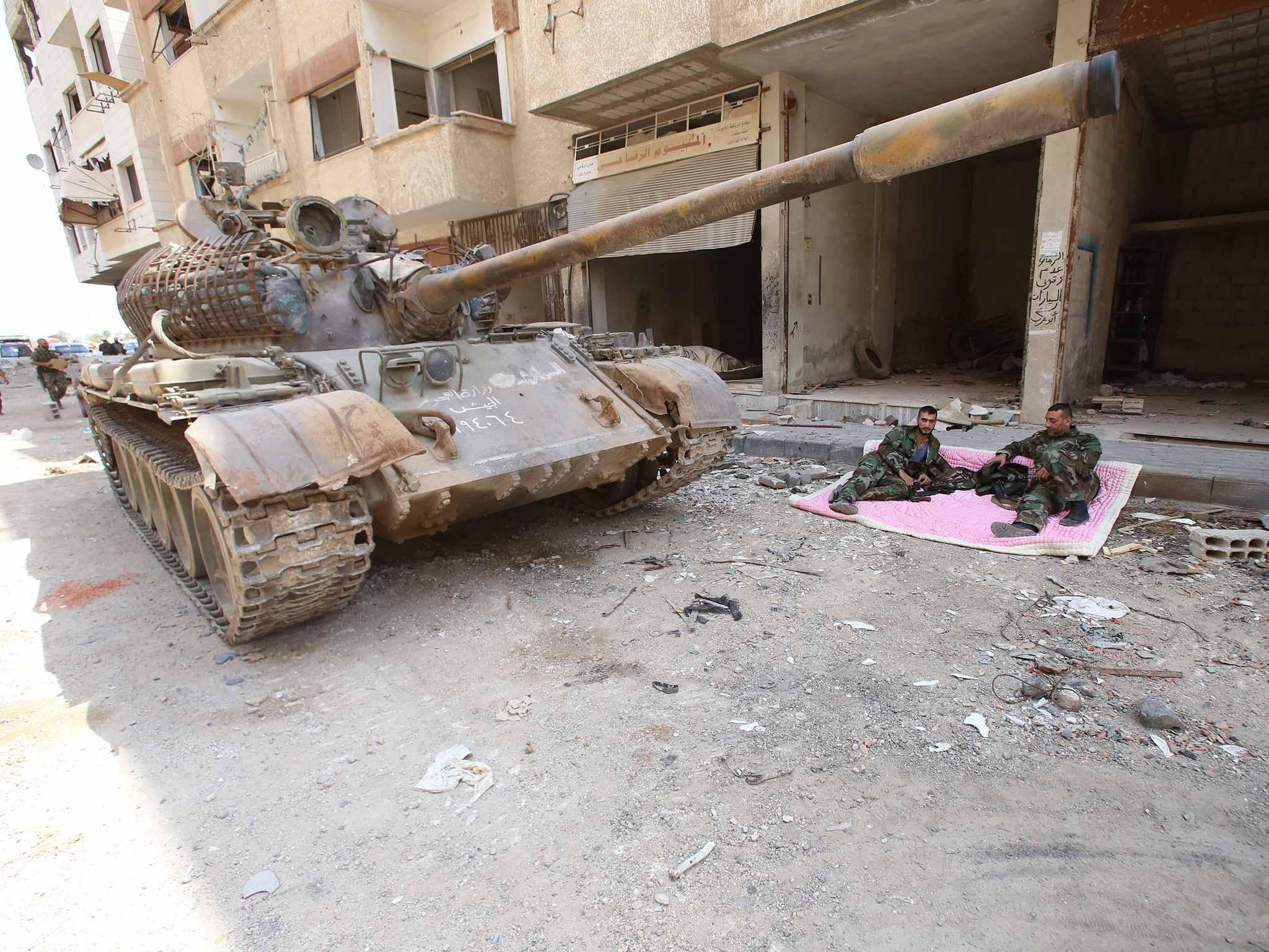 Syrian army soldiers taking a break in Daraya, after Assad’s government agreed a deal to take control of the town last month