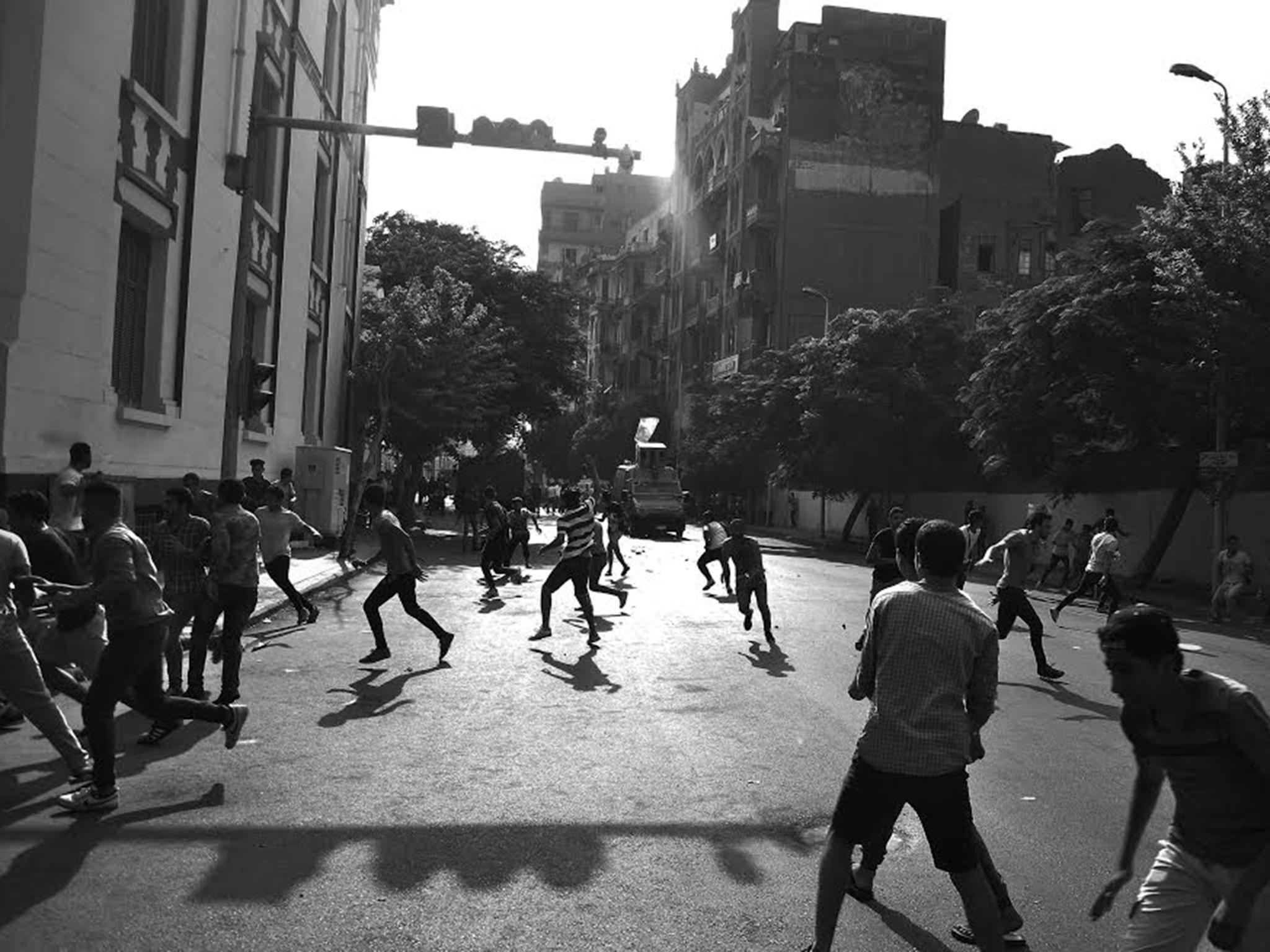 Protesters and security forces clash in Tahrir Square earlier this summer