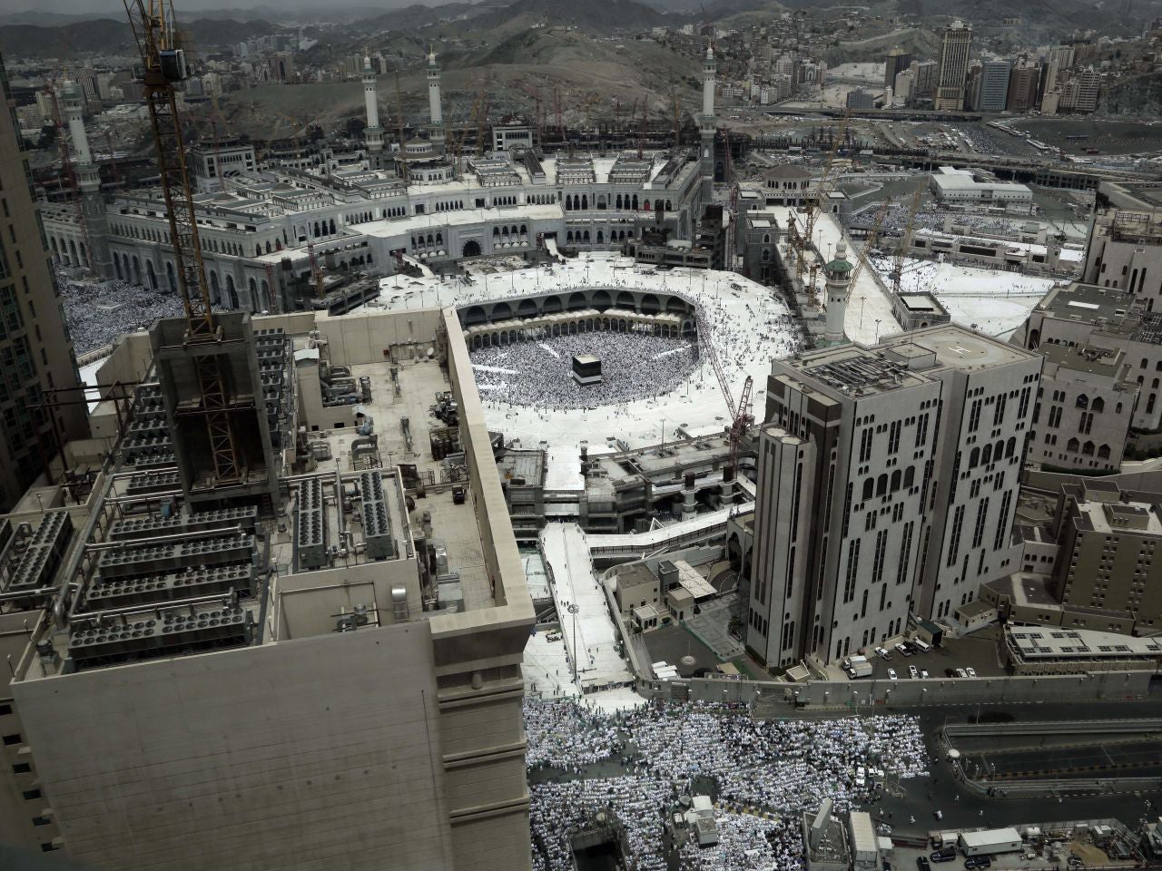 Muslim pilgrims prepare them selves for Friday prayer in front of the Kaaba