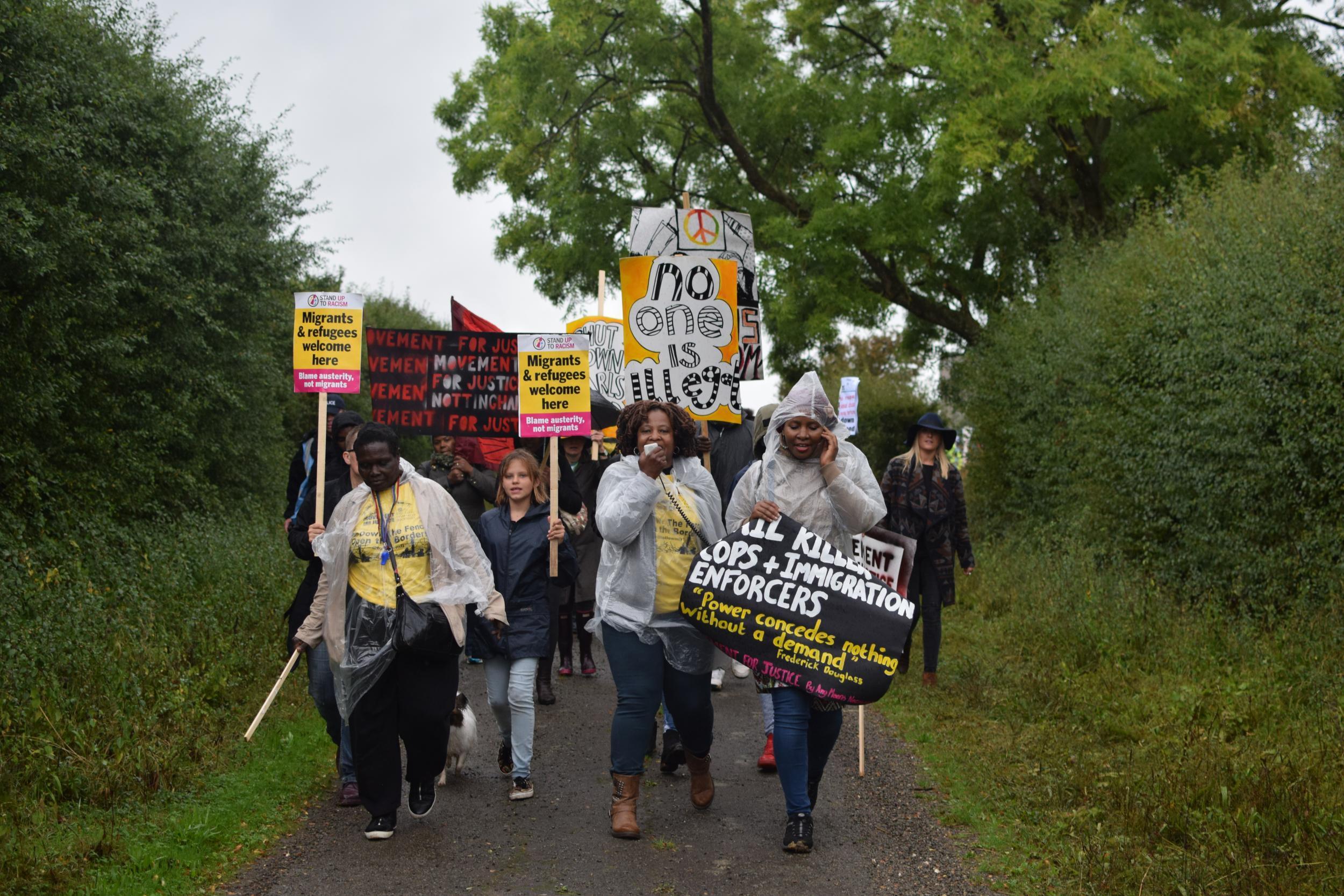 Demonstrators chant as they make their way to the Yarl's Wood Immigration Removal Centre in Milton Ernest