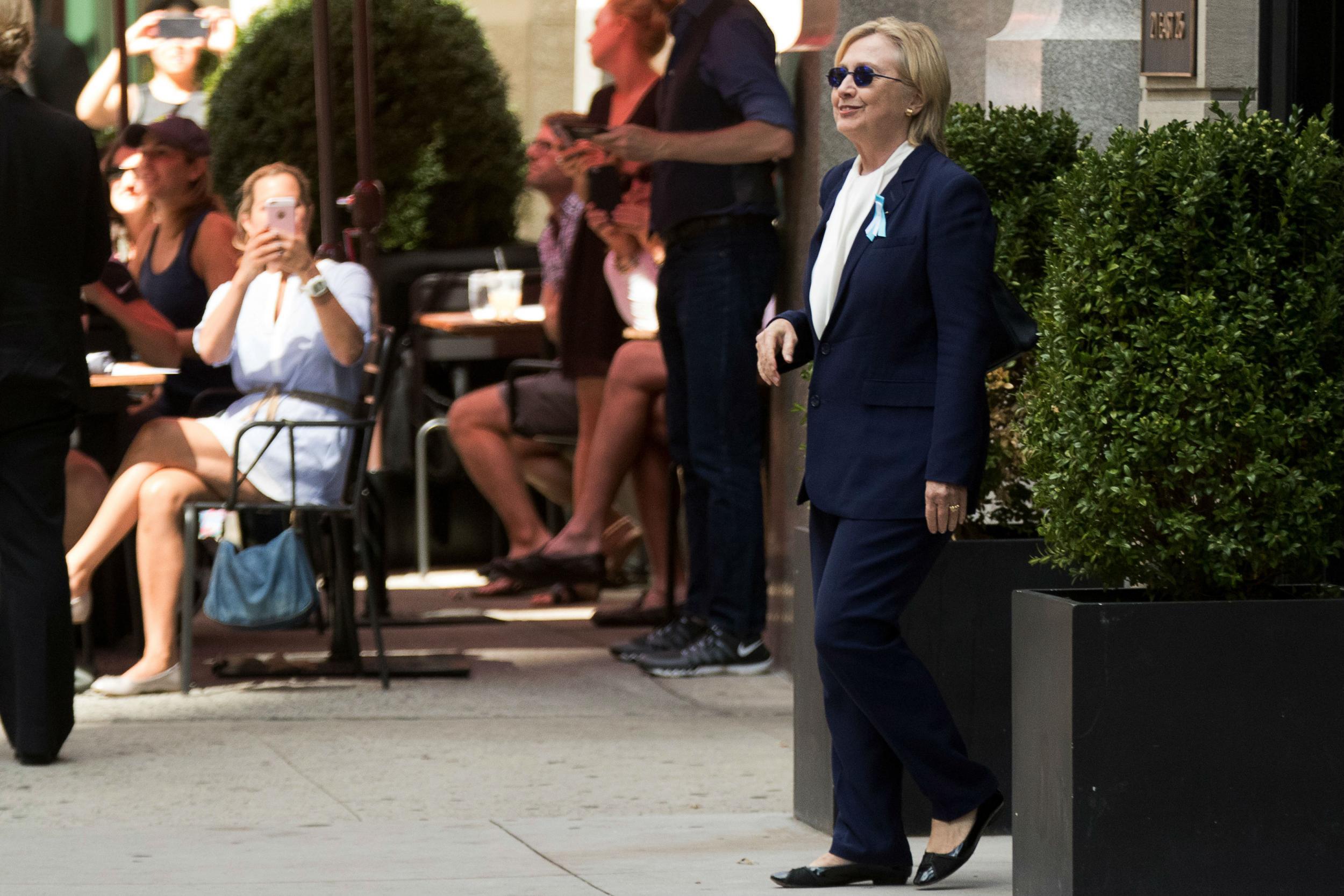 Ms Clinton had been wearing a dark suit on a humid day