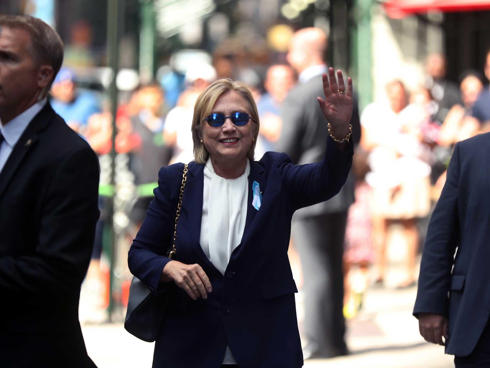 Hillary Clinton waves after leaving an apartment building in New York