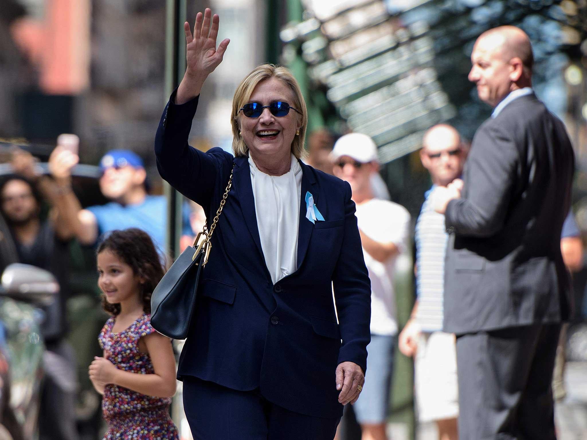 Ms Clinton walks, smiling and unaided, out of her daughter's apartment shortly after the stumble