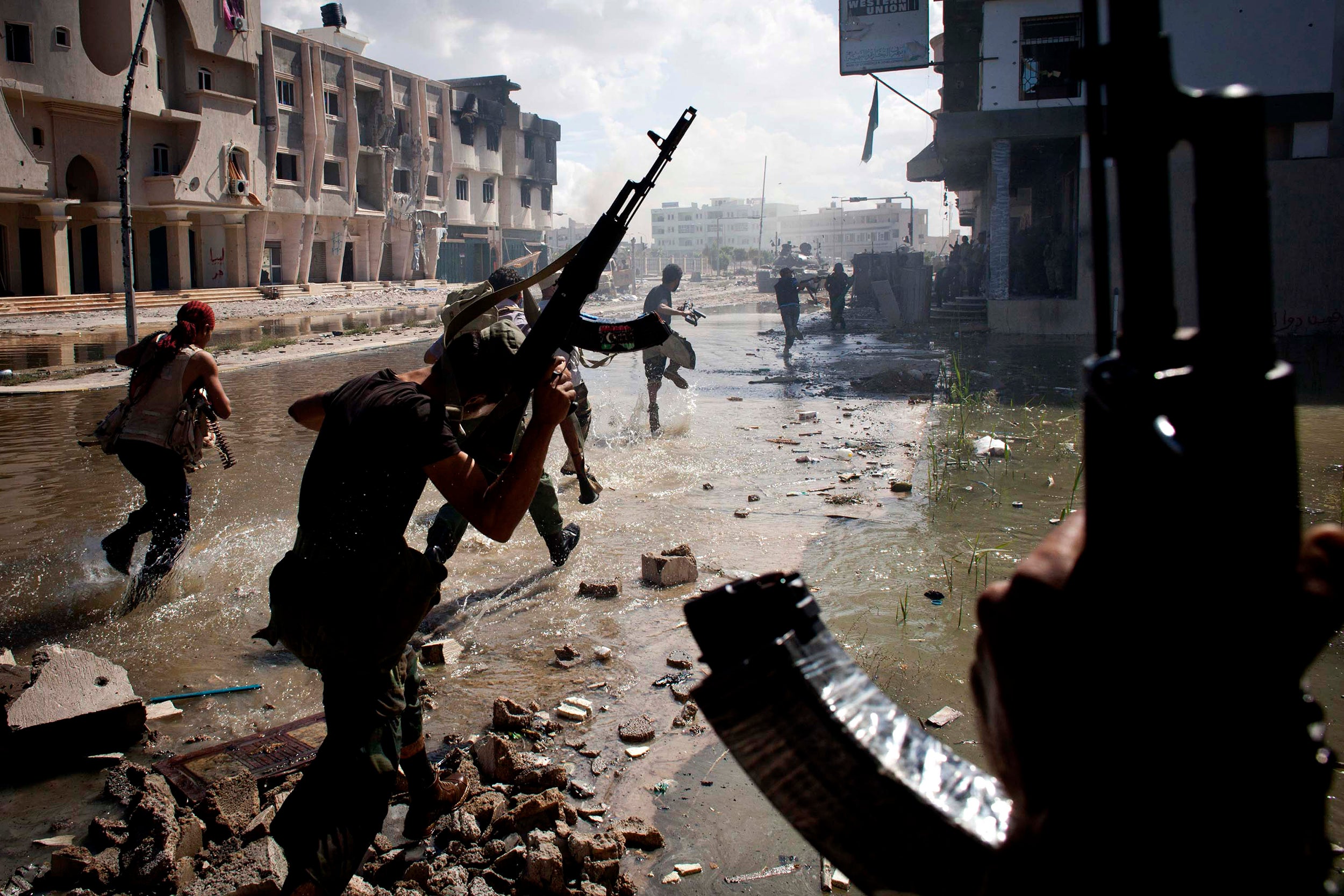 National Transitional Council fighters take part in a street battle in Sirte, Libya in the final assault on Gaddafi's hometown in 2011