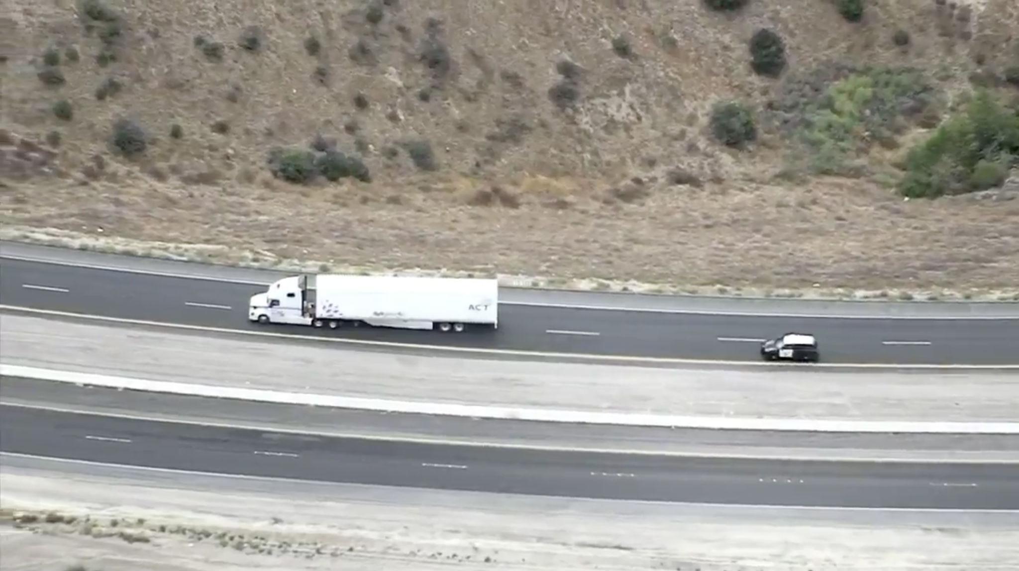 A California Highway Patrol cruiser pursues the rig through the Southern California desert on Tuesday