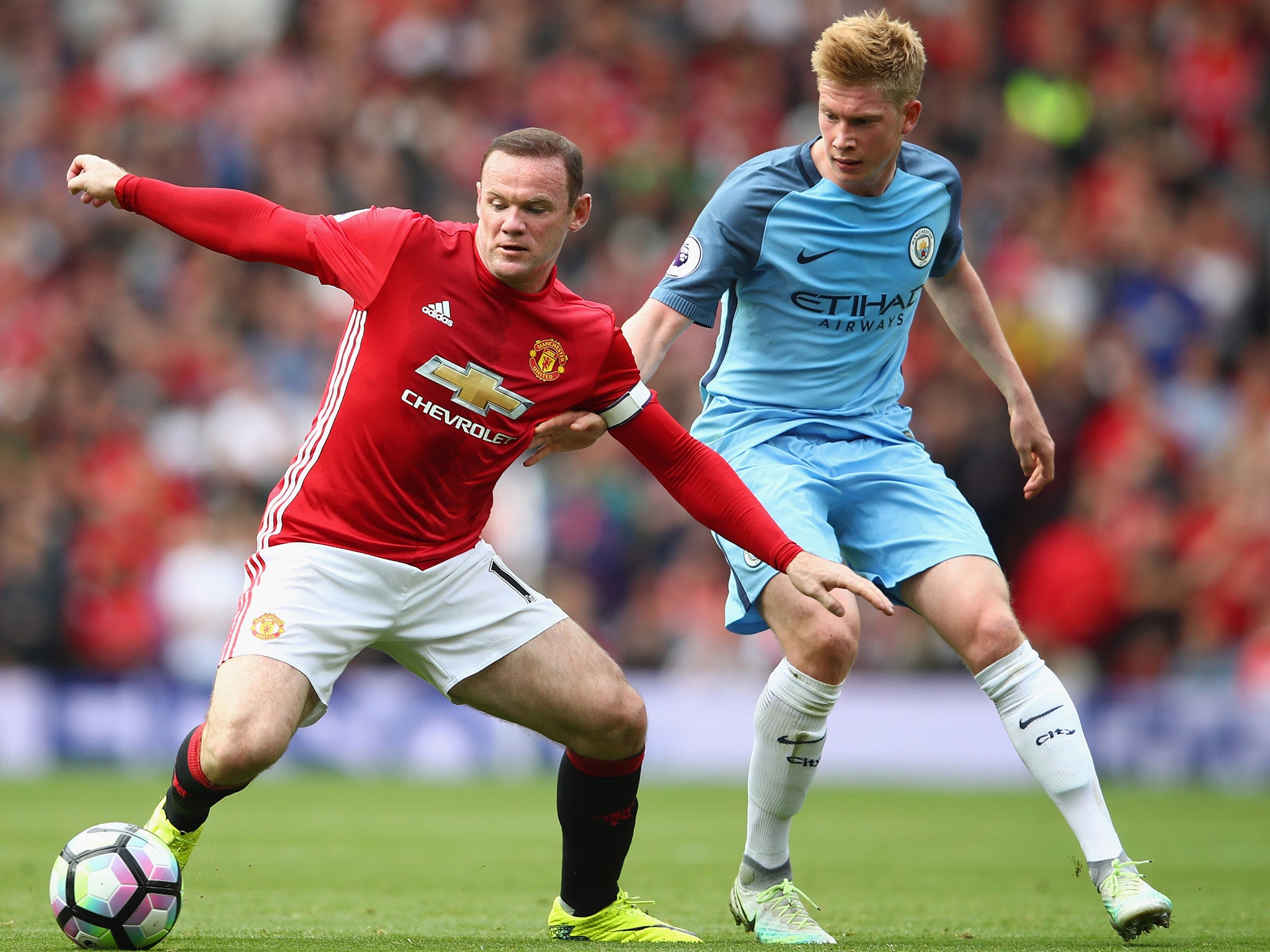 Wayne Rooney attempts to ward off Kevin de Bruyne in the Manchester derby