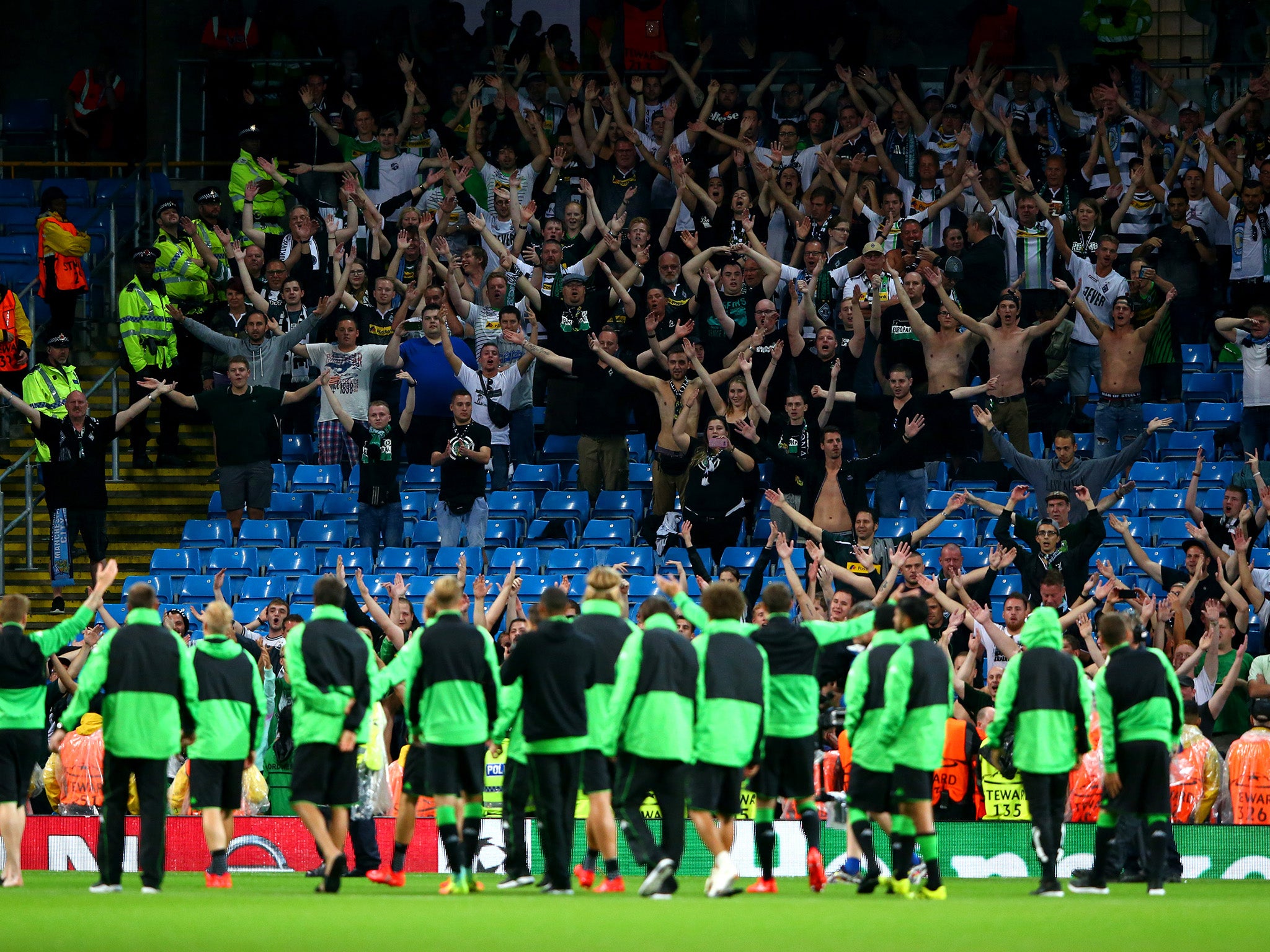 Borussia Monchengladbach players applaud their fans after the game was postponed