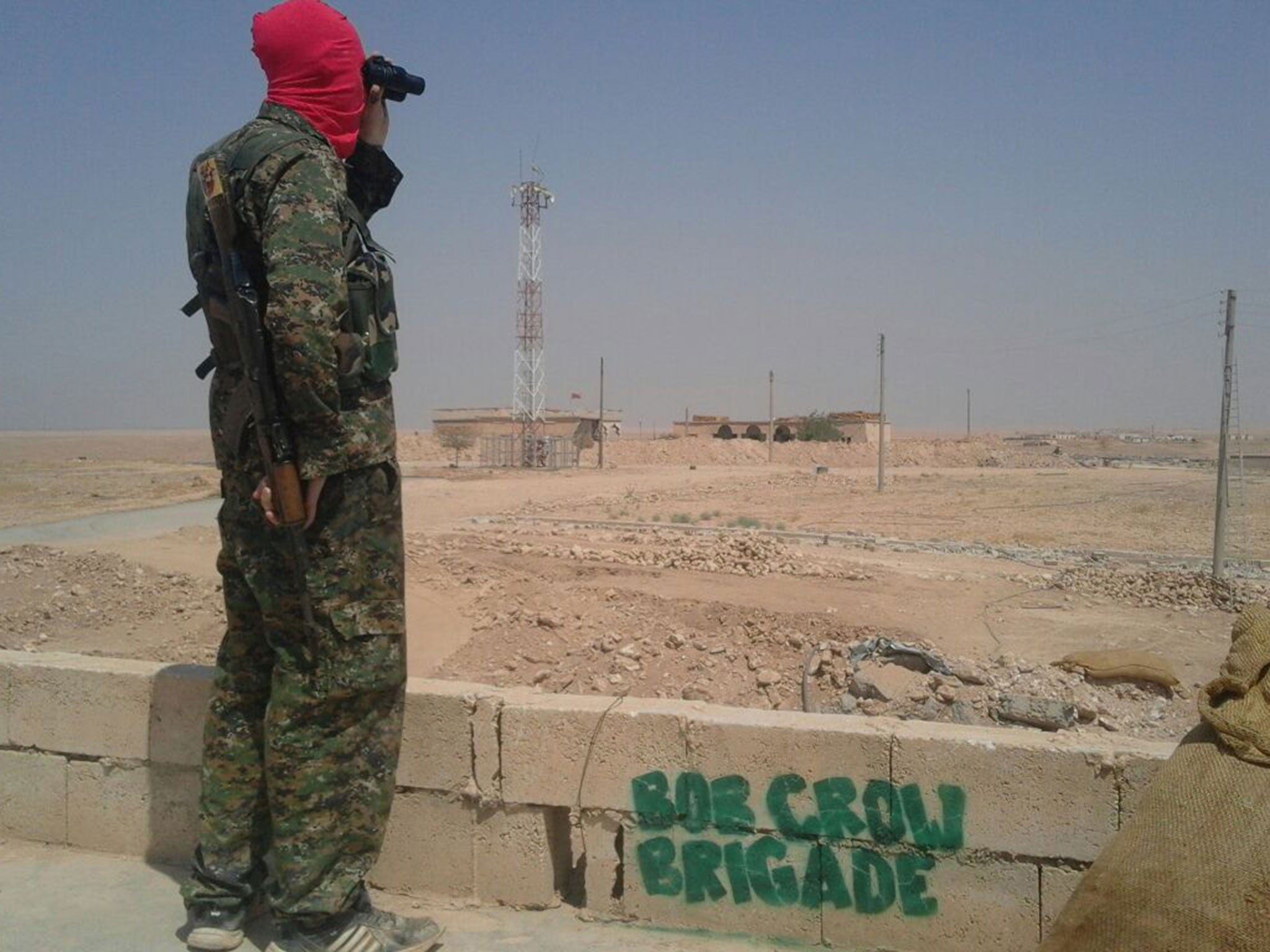 A member of the British anti-Isis volunteer group the Bob Crow Brigade keeping watch in northern Syria