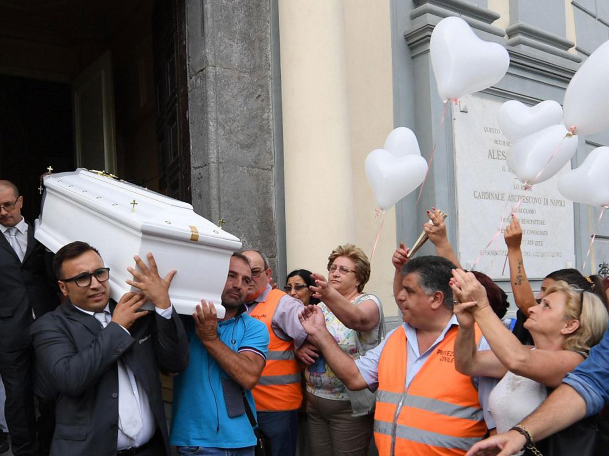 The coffin of Tiziana Cantone being carried out of a church at the end of her funeral service in Casalnuovo, Naples, Italy