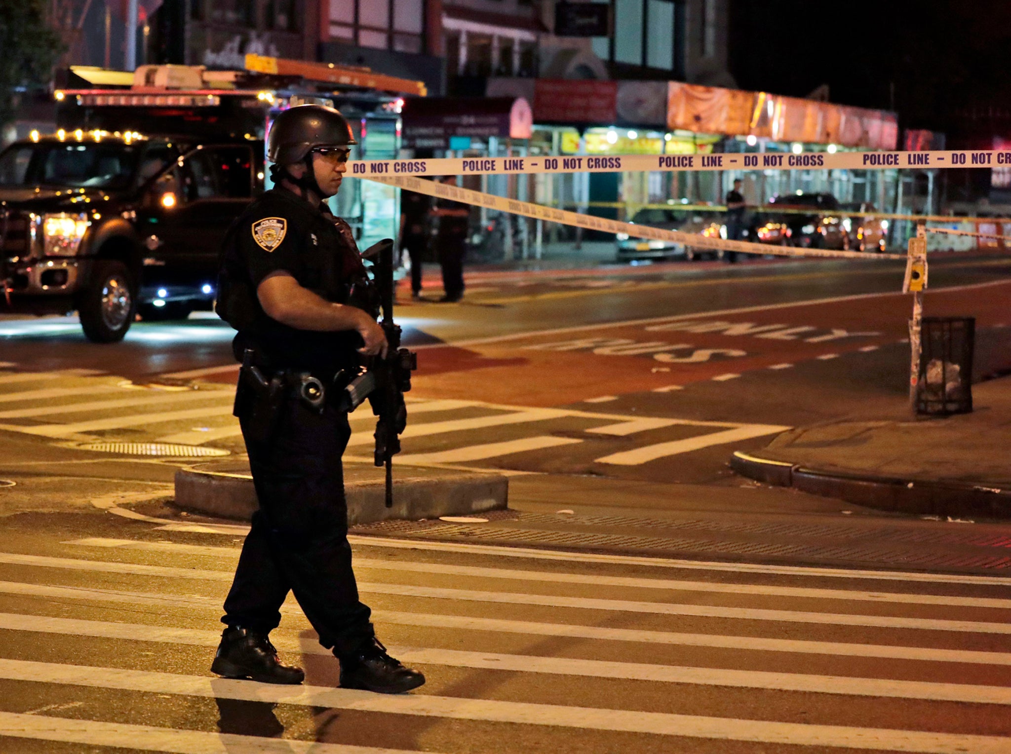 A New York City Police emergency service heavy weapons officer guards close to the scene of an explosion on 23rd Street between 6th and 7th Avenue