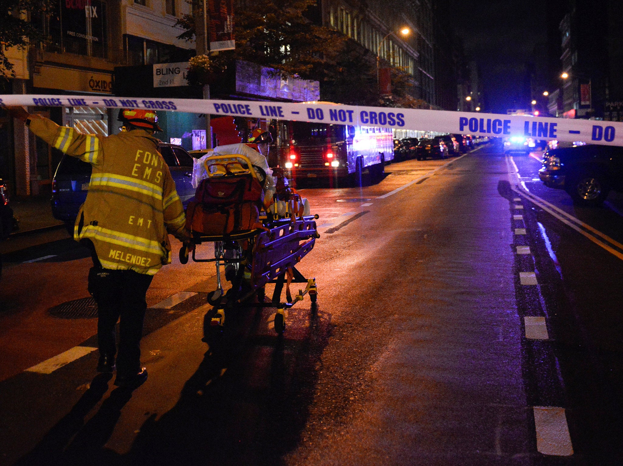 A New York City firefighter uses a wheeled stretcher to carry supplies near the site of the explosion