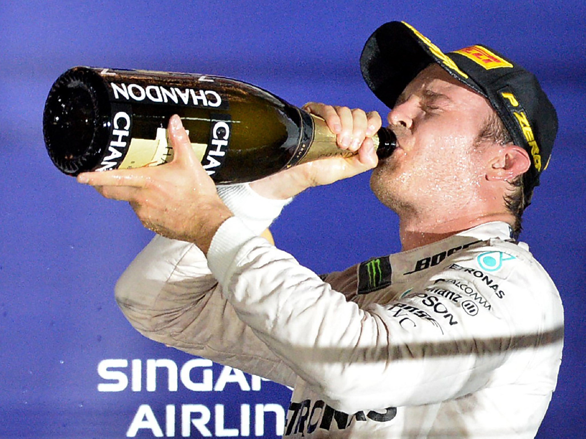 Nico Rosberg takes a swig of champagne in celebration of winning in Singapore