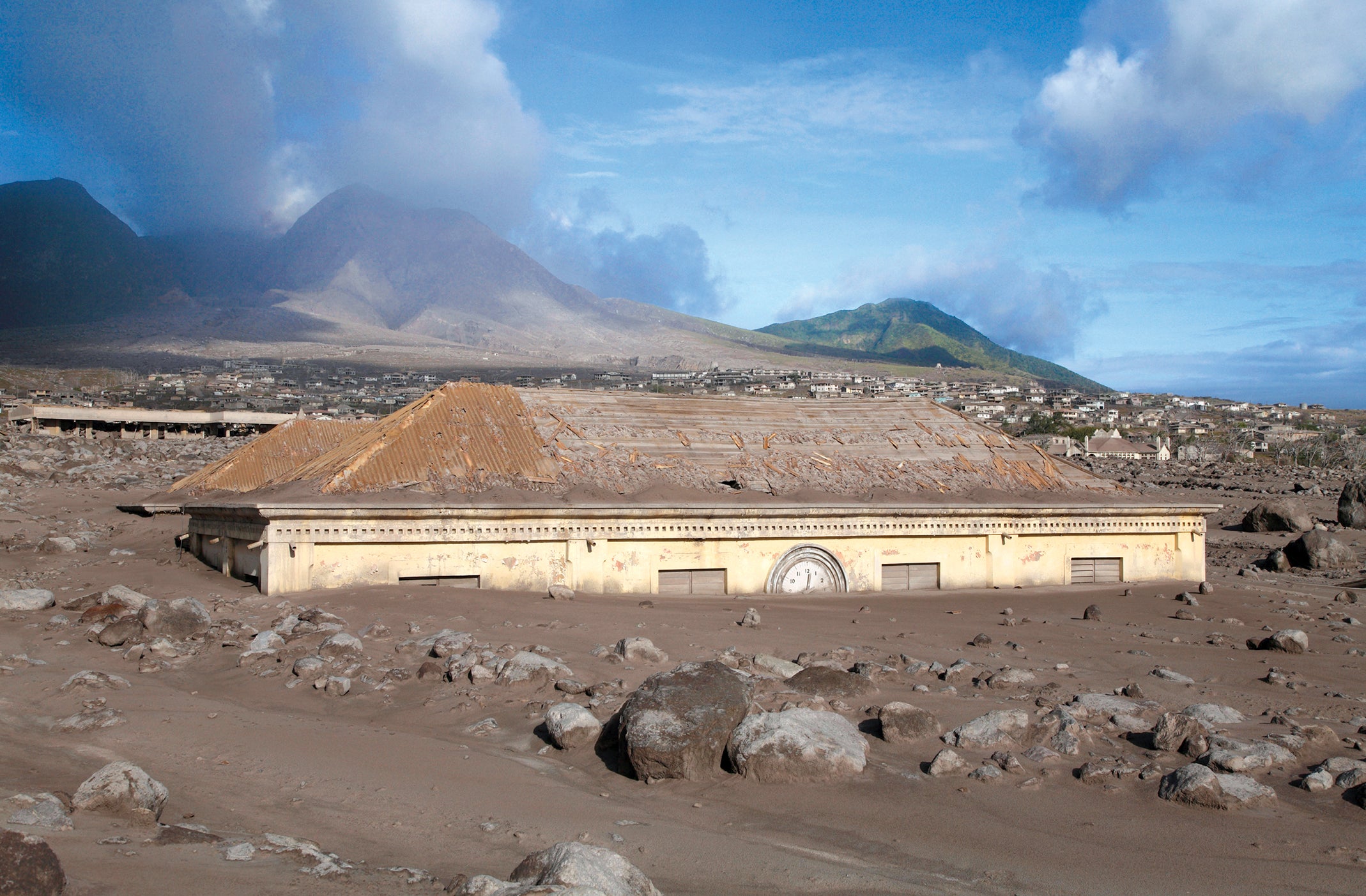 Plymouth's ruined courthouse, still buried in ash after a devastating volcanic eruption