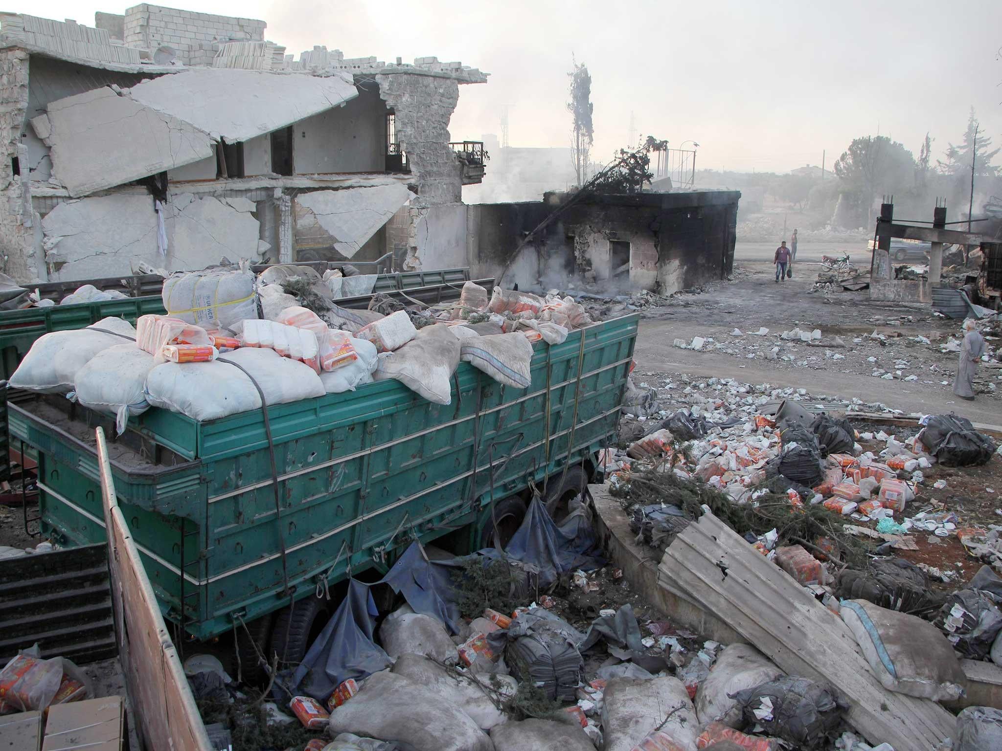 Supplies are left strewn across the ground in Uram al-Kubra, where around 20 humanitarian volunteers were killed in an attack (Getty)