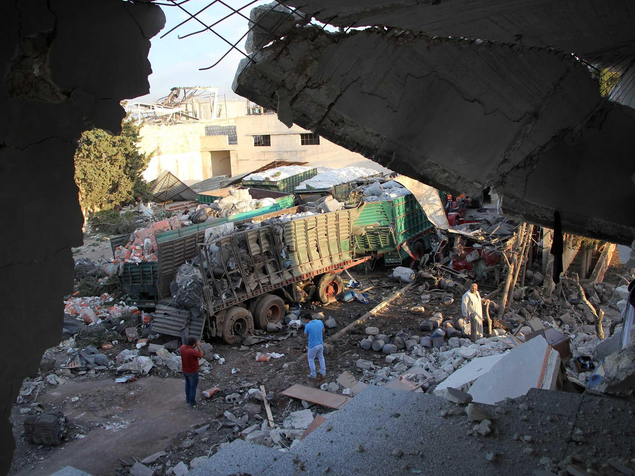 Aid is seen strewn across the floor in the town of Orum al-Kubra on the western outskirts of the northern Syrian city of Aleppo, the morning after a convoy delivering aid was hit by a deadly air strike