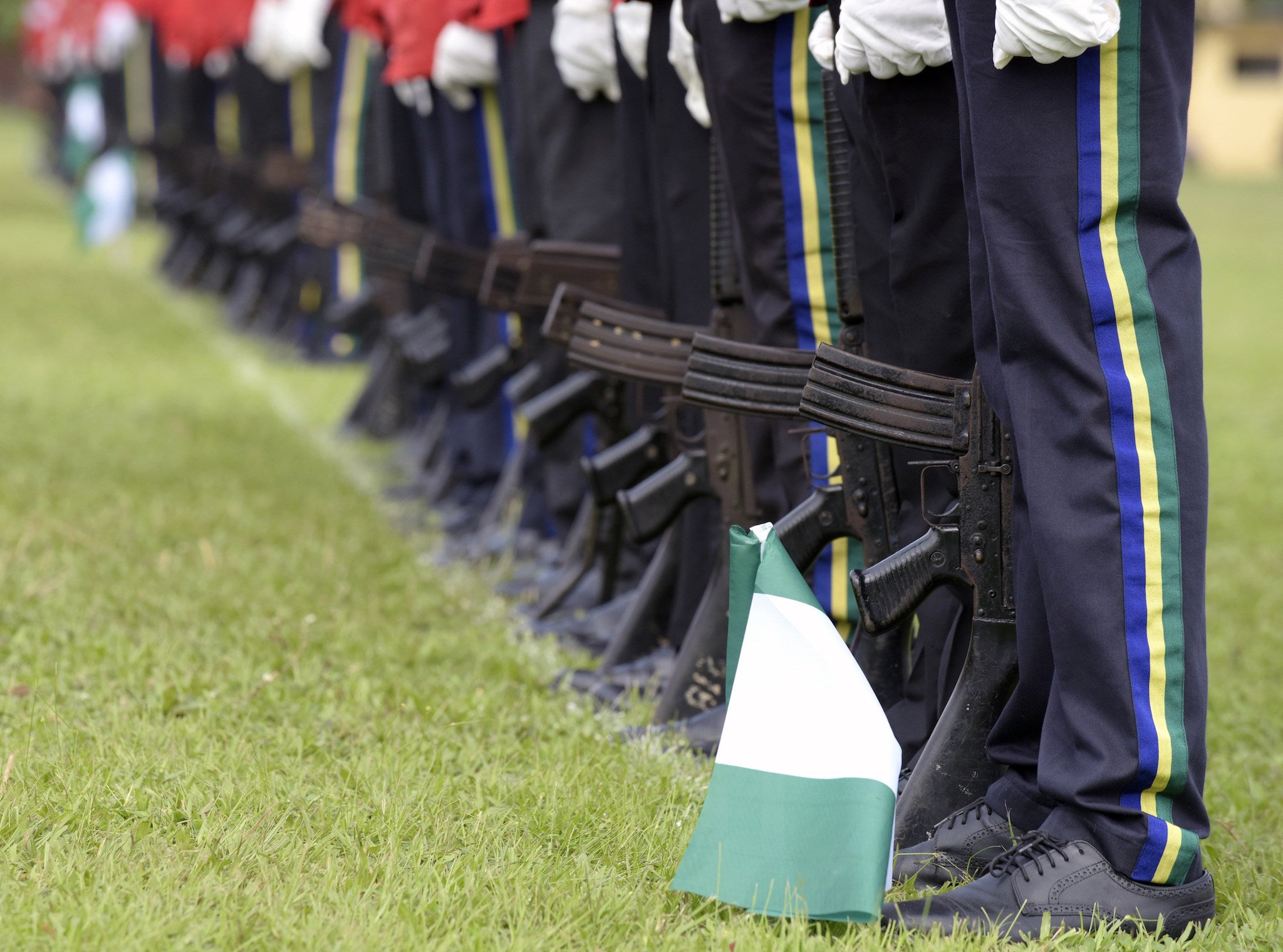 Nigerian policemen stand in line on 1 October, 2015 as President Muhammadu Buhari called for an end to 'unruly behaviour' in the country, saying progress could not happen without a change in citizens' attitudes