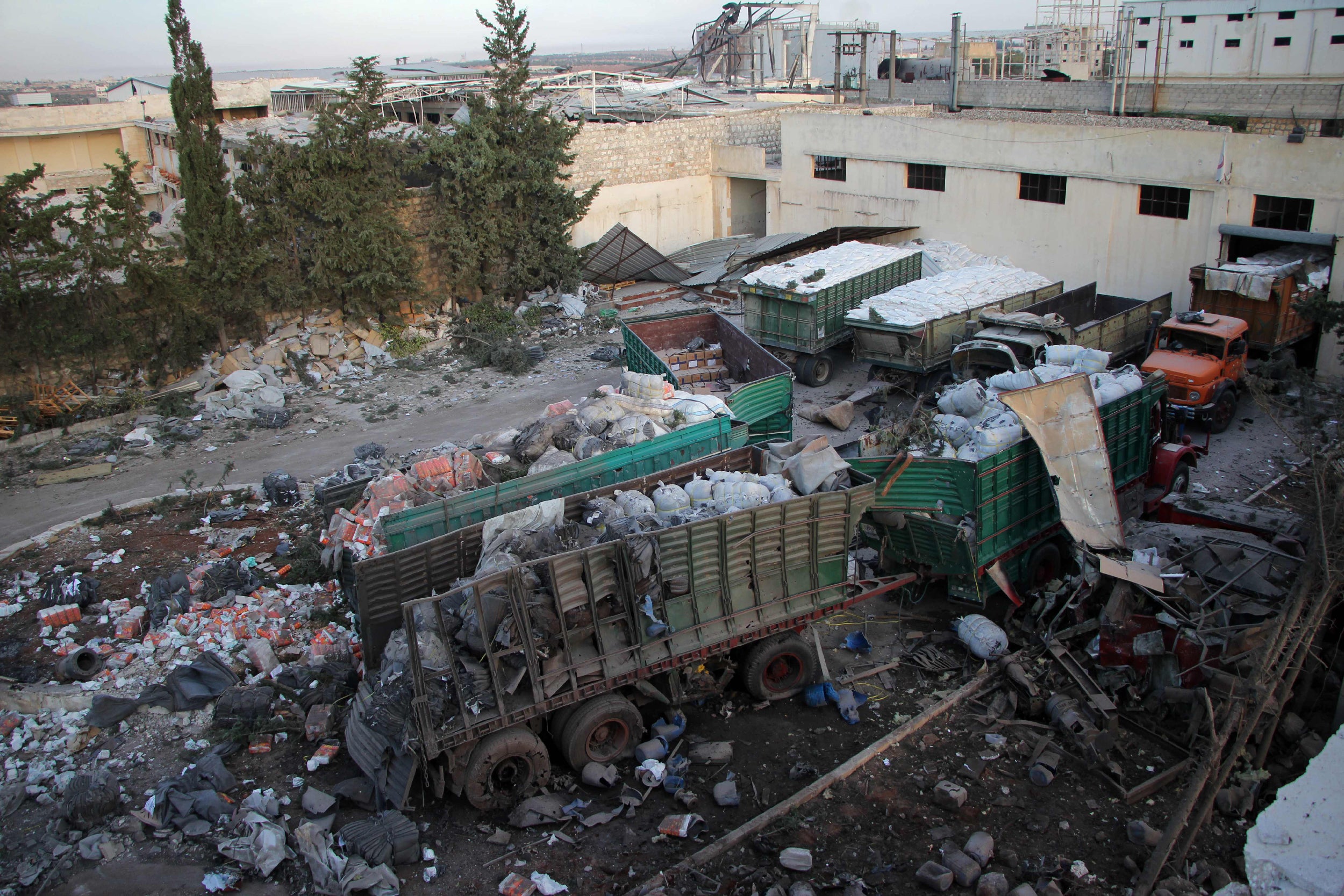 Supplies are left scattered by the attack in Urm al-Kubra, near Aleppo, in which more than a dozen humanitarian volunteers were killed