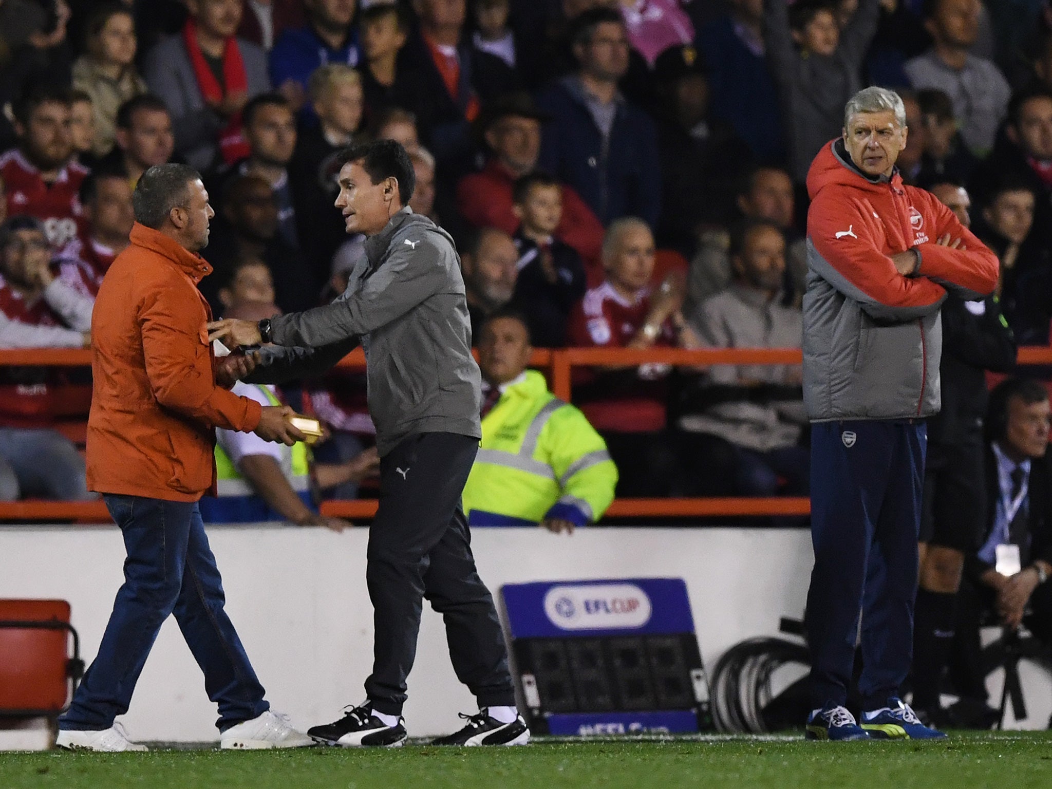 Wenger notices the fan offering him the pie