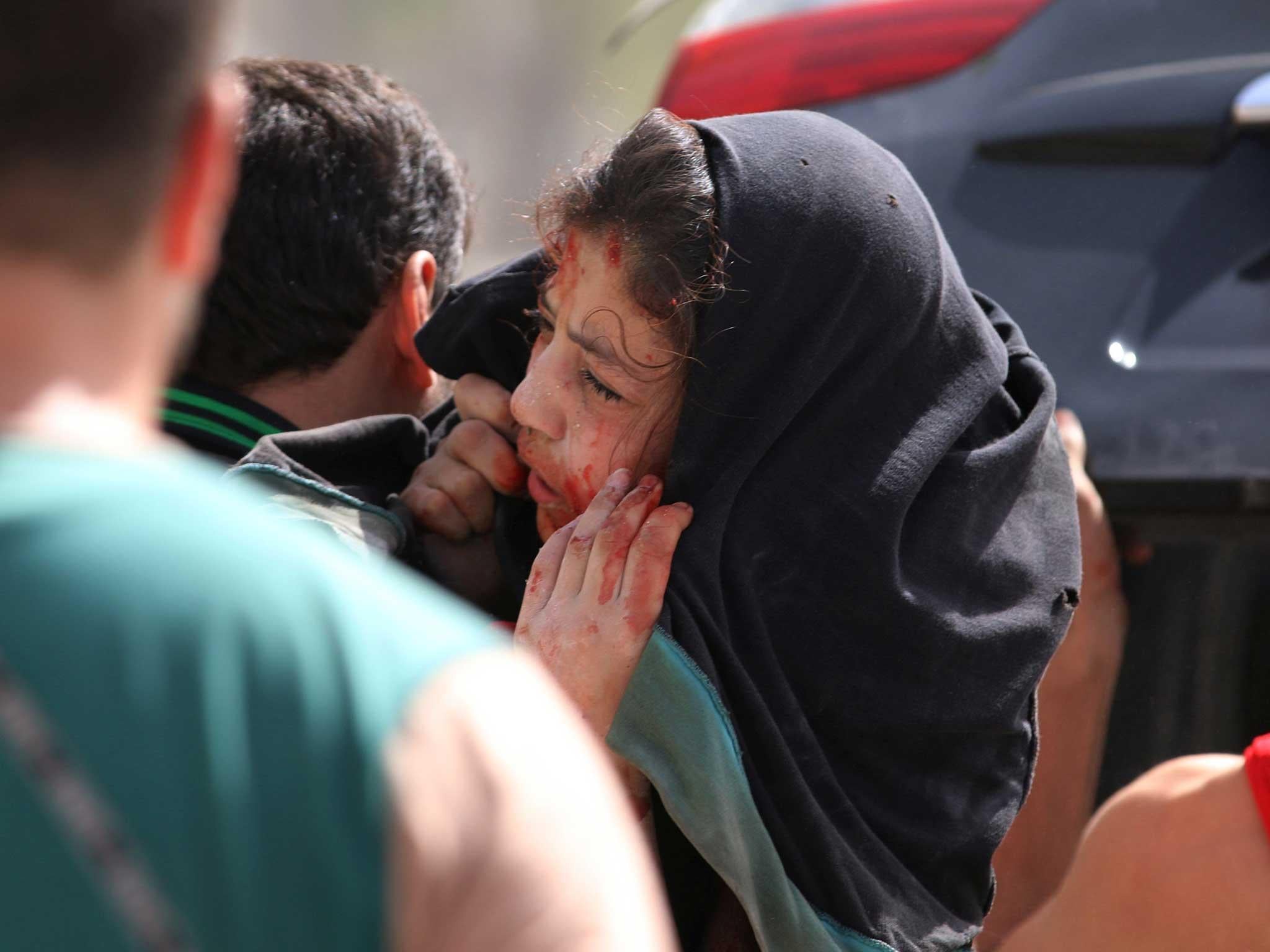 A man carries an injured girl after airstrikes on the rebel held al-Qaterji neighbourhood of Aleppo