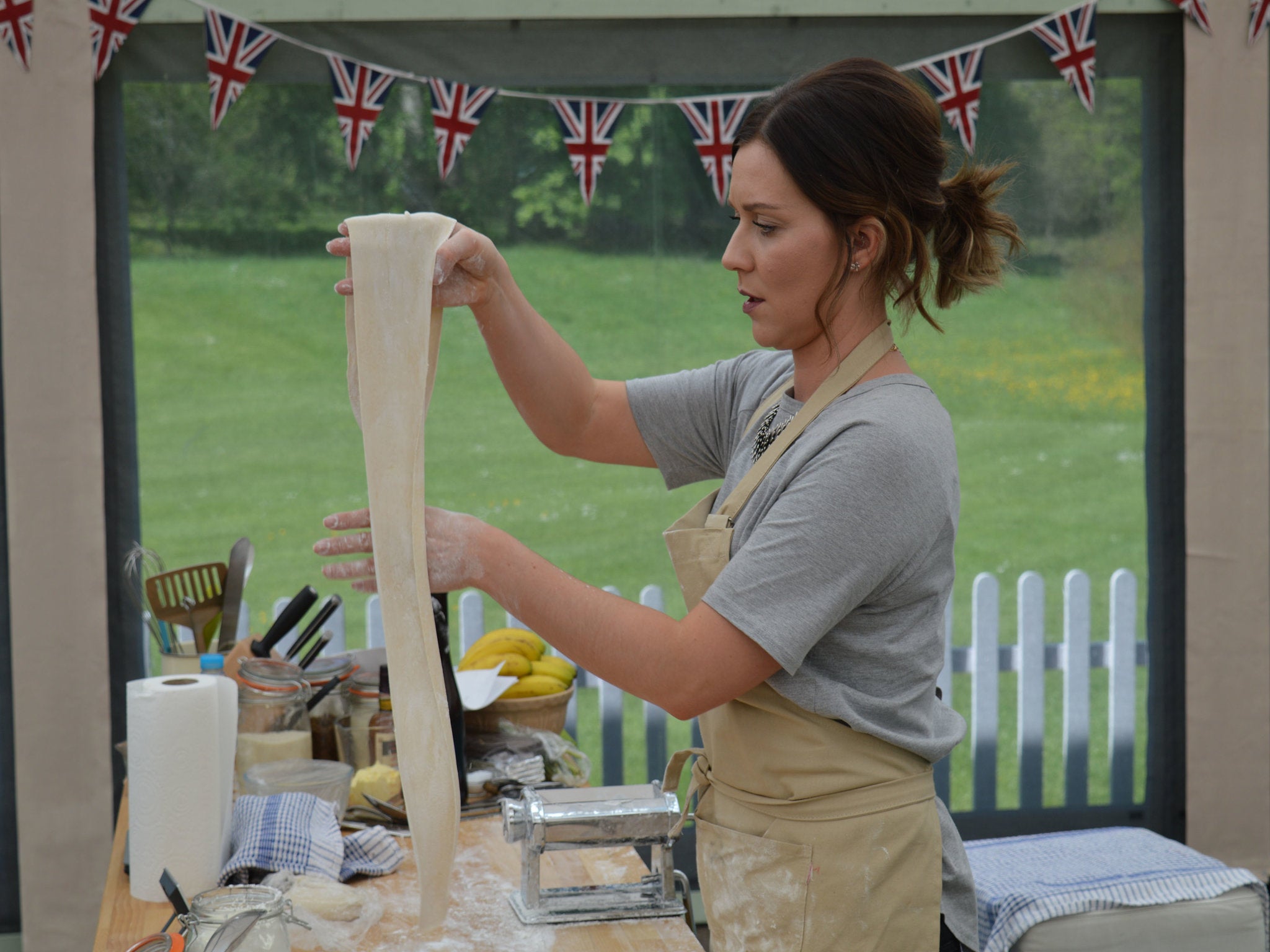 Candice rolling her pastry on a pasta machine